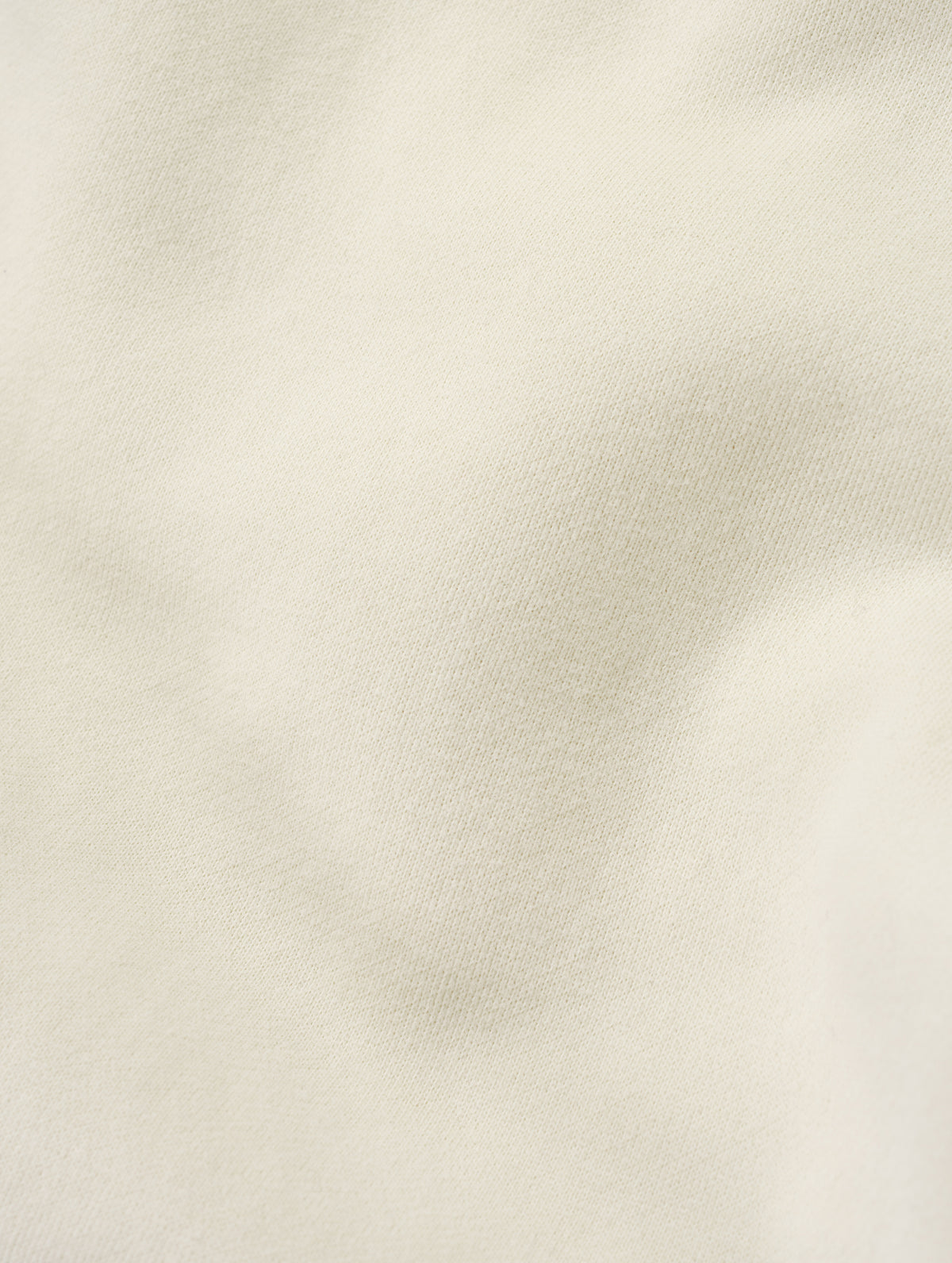 Closeup detailed view of the ultra-soft carbon brushed fleece cotton on the Rylan Sweat Pant in Bone from AETHER Apparel. 