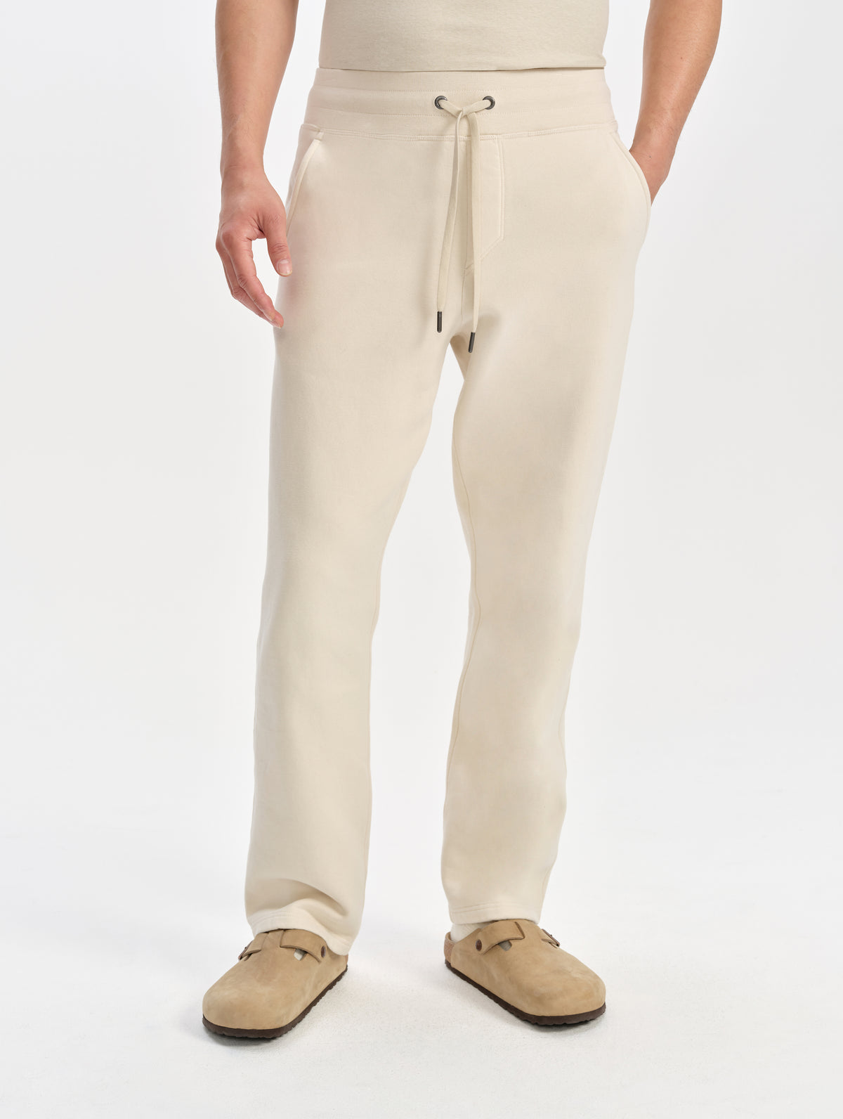 Front lower-body view of man wearing the Rylan Sweat Pant in Bone from AETHER Apparel. 