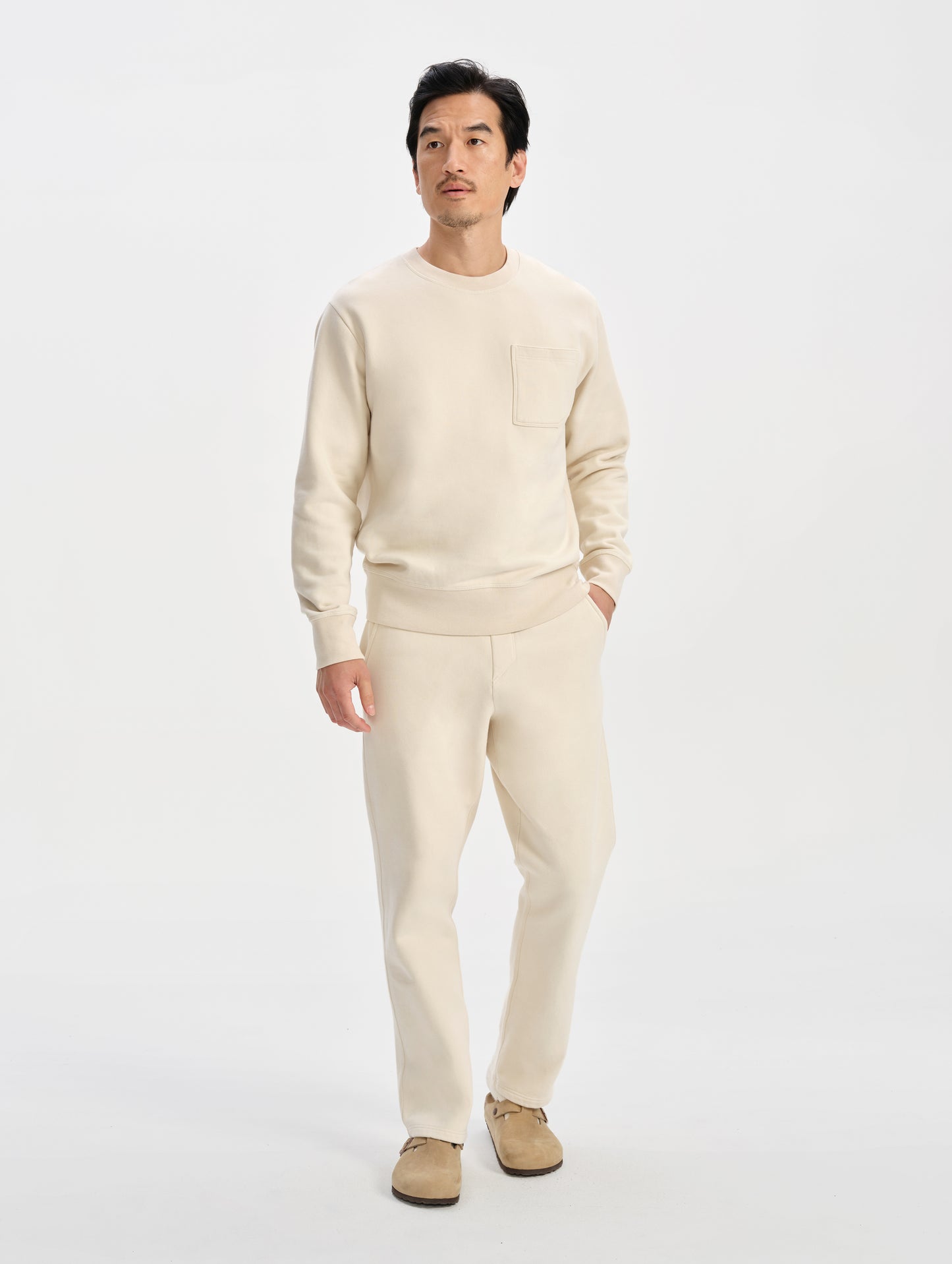 Front full-body view of man wearing the Rylan Sweat Pant in Bone from AETHER Apparel. 