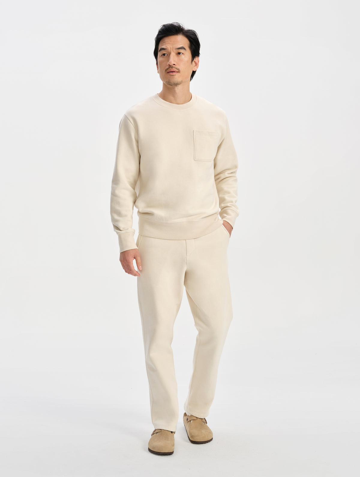 Front full-body view of man wearing the Rylan Sweat Pant in Bone from AETHER Apparel. 