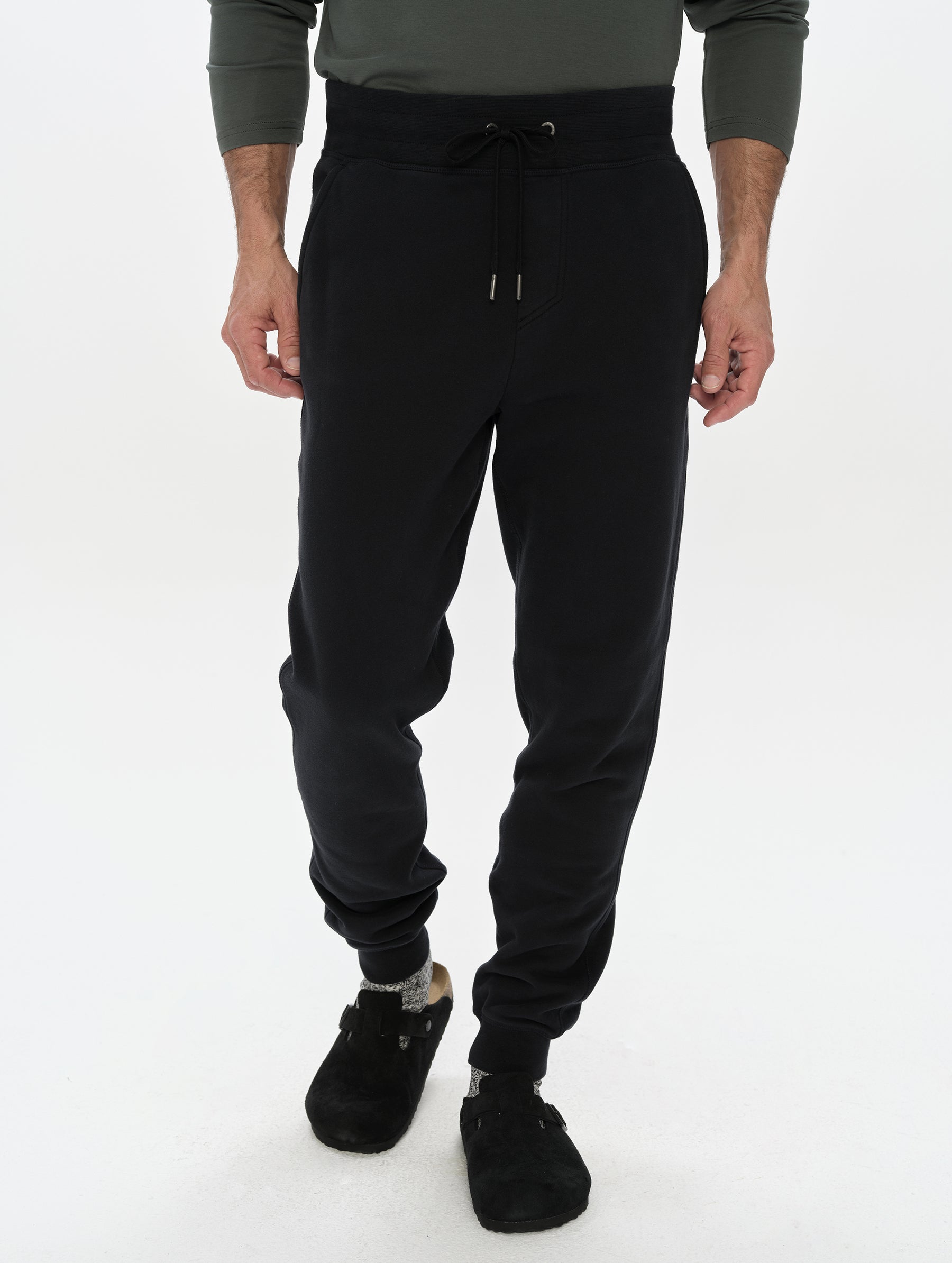 Front, lower-body view of man wearing the Rylan Cuffed Sweatpant in Onyx Black from AETHER Apparel.