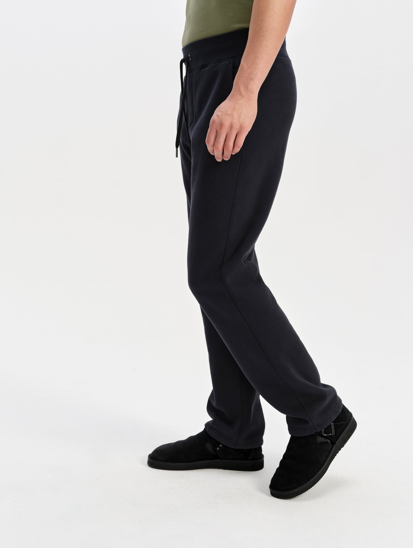 Side profile lower-body view of man wearing the Rylan Sweat Pant in Onyx Black from AETHER Apparel. 