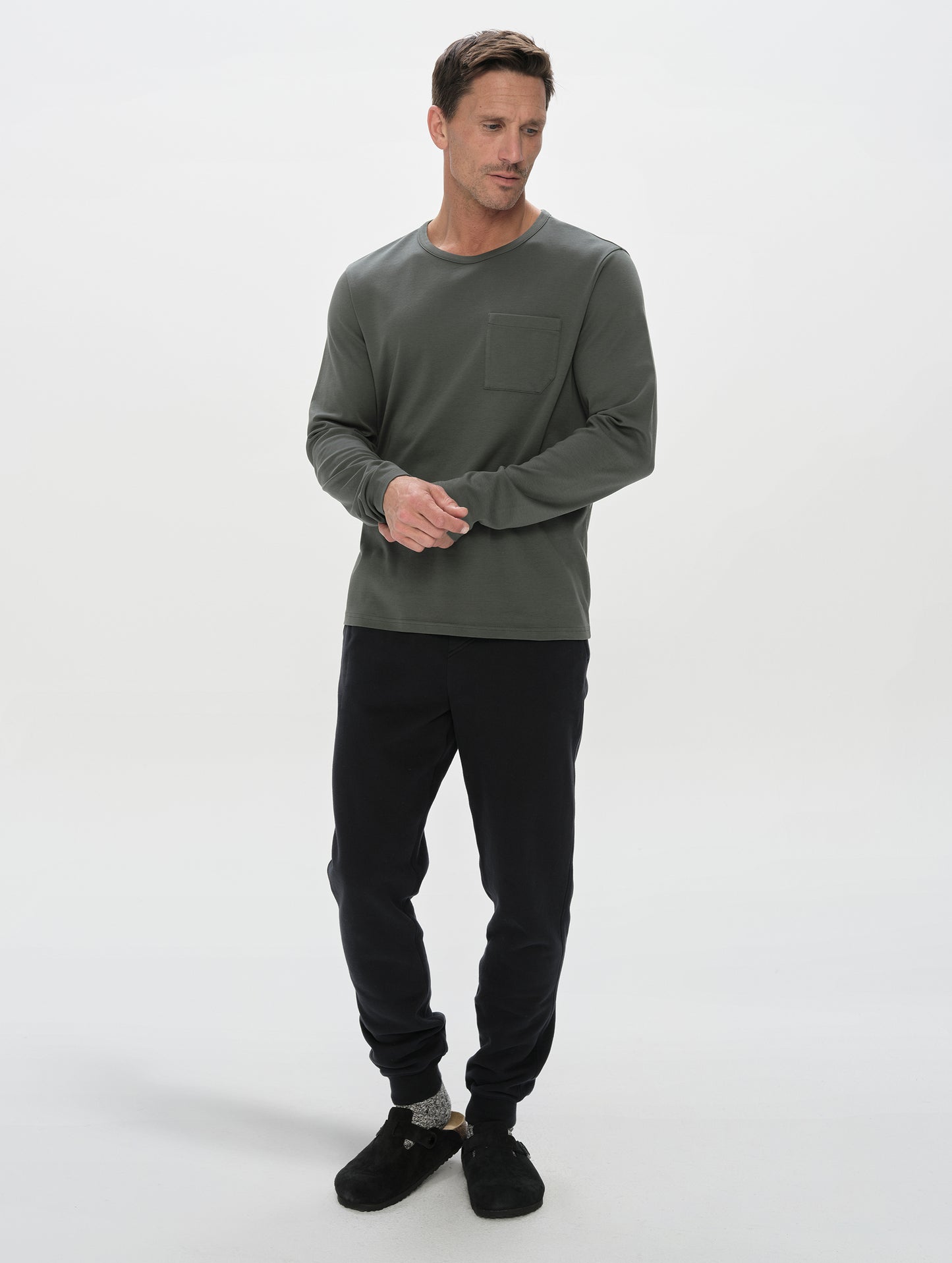 Front, full-body view of man wearing the Rylan Cuffed Sweatpant in Onyx Black from AETHER Apparel.