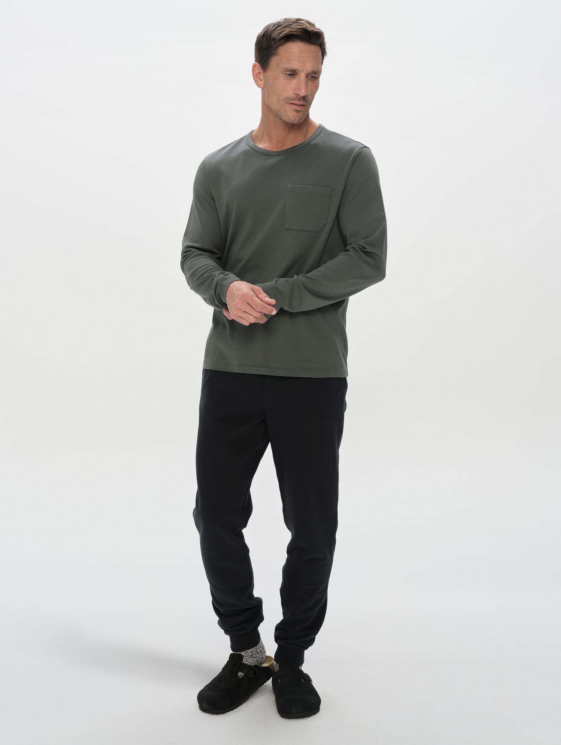 Front, full-body view of man wearing the Rylan Cuffed Sweatpant in Onyx Black from AETHER Apparel.