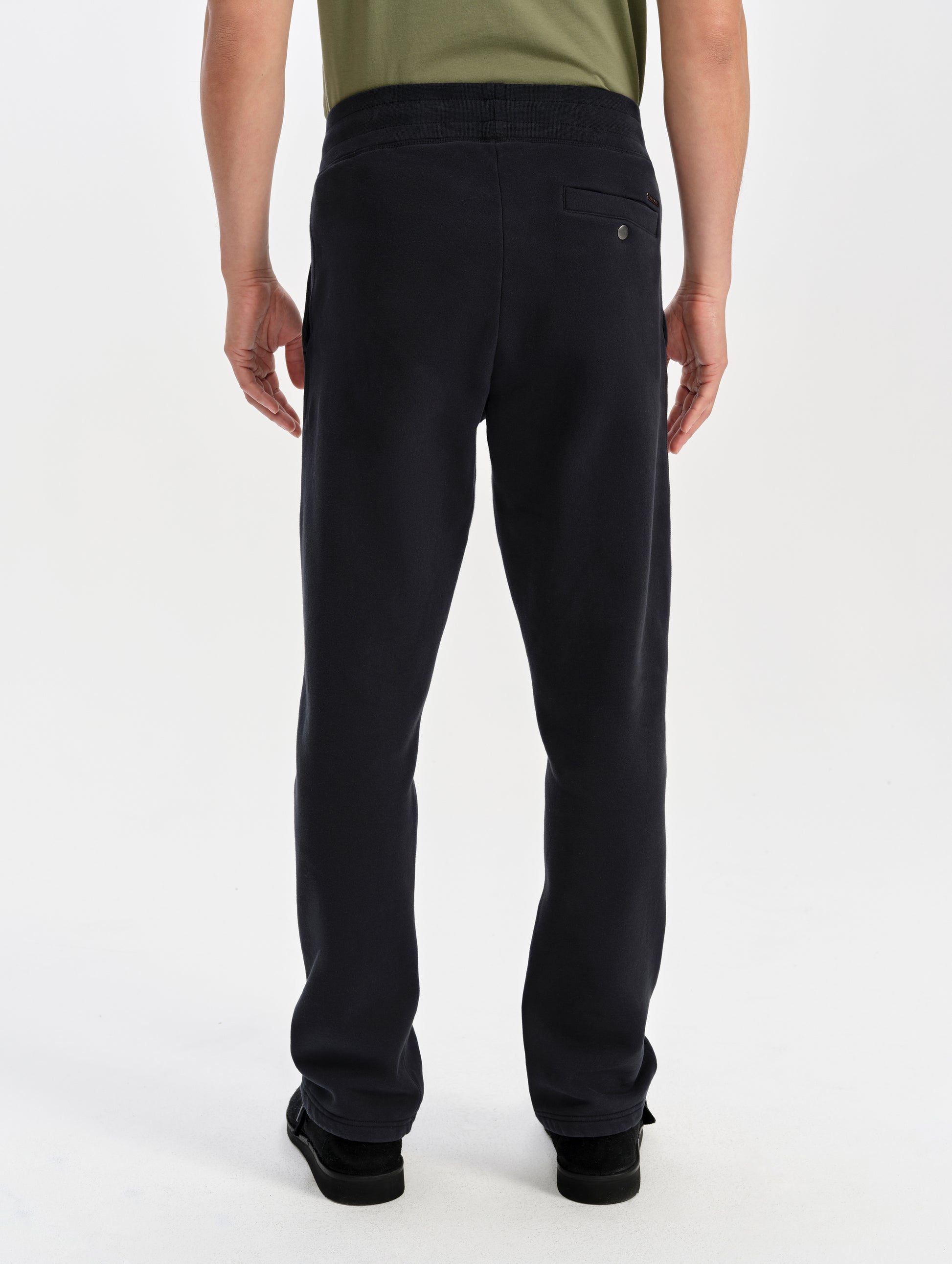 Rear lower-body view of man wearing the Rylan Sweat Pant in Onyx Black from AETHER Apparel. 