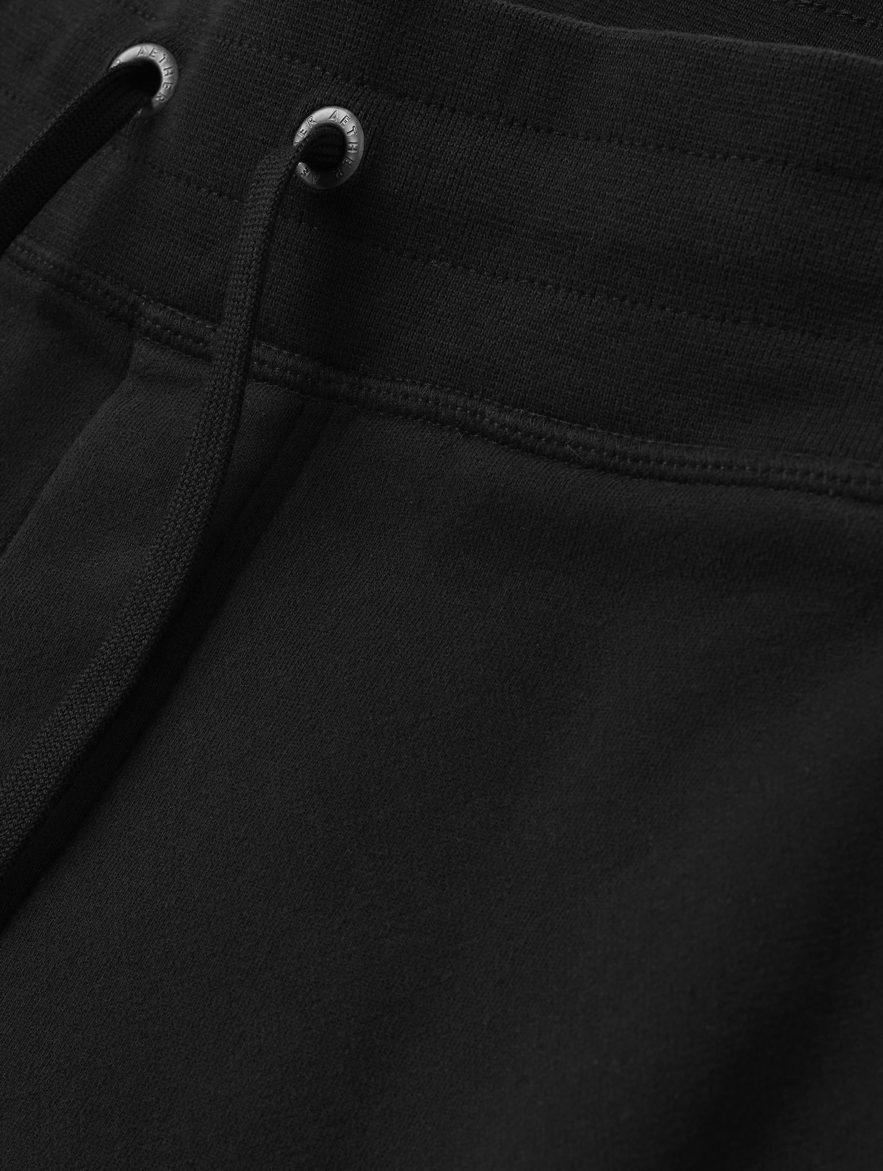 Closeup detailed view of the drawstring closure on the Rylan Cuffed Sweatpant in Onyx Black from AETHER Apparel.