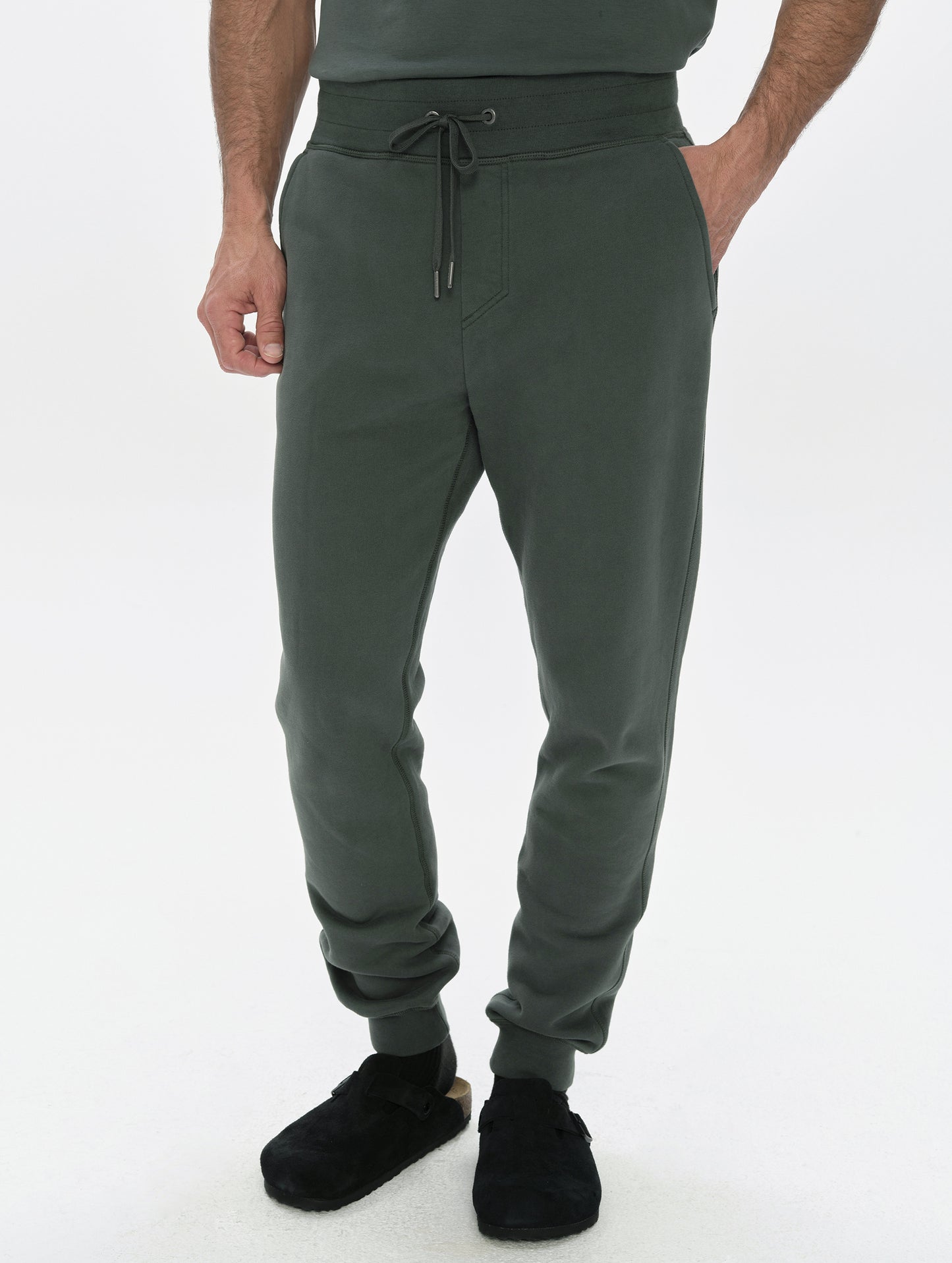 Front, lower-body view of man wearing the Rylan Cuffed Sweatpant in Saville Green  from AETHER Apparel.