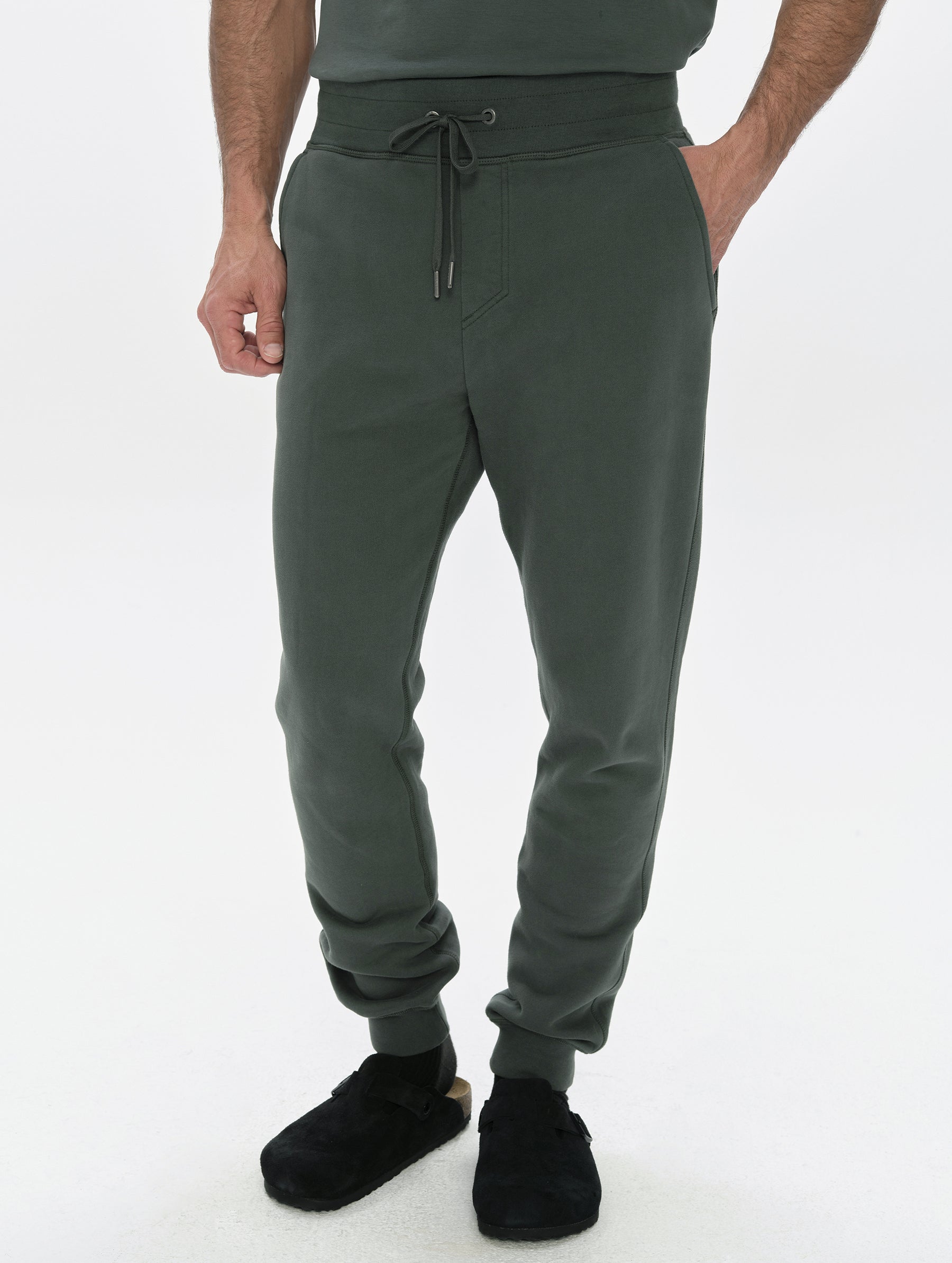 Front, lower-body view of man wearing the Rylan Cuffed Sweatpant in Saville Green  from AETHER Apparel.