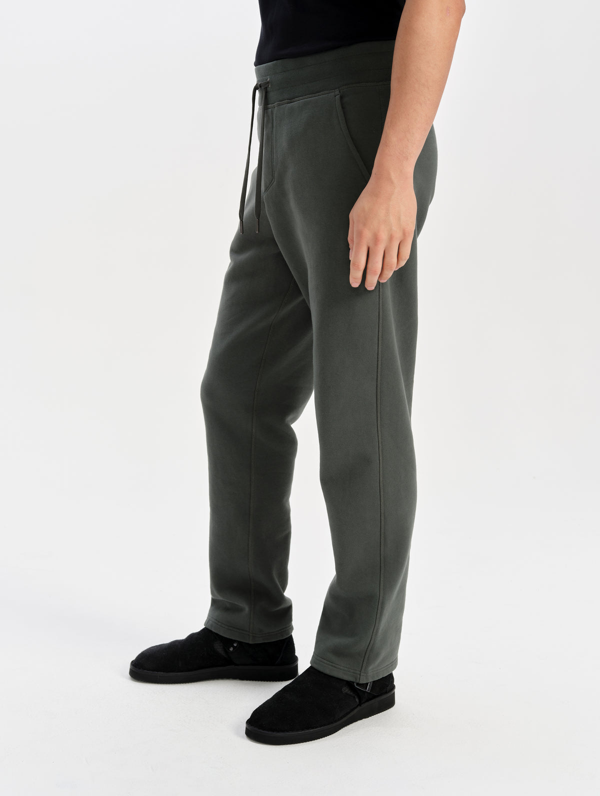 Side profile lower-body view of man wearing the Rylan Sweat Pant in Saville Green from AETHER Apparel. 