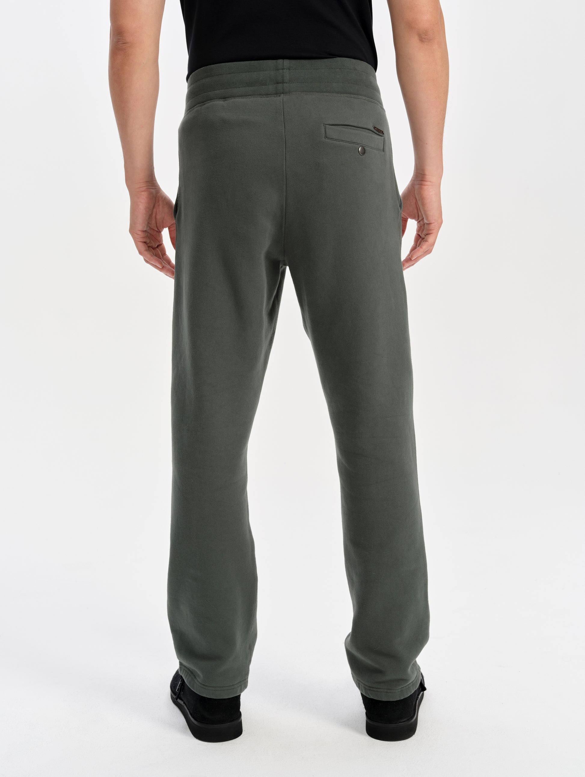 Rear lower-body view of man wearing the Rylan Sweat Pant in Saville Green from AETHER Apparel. 