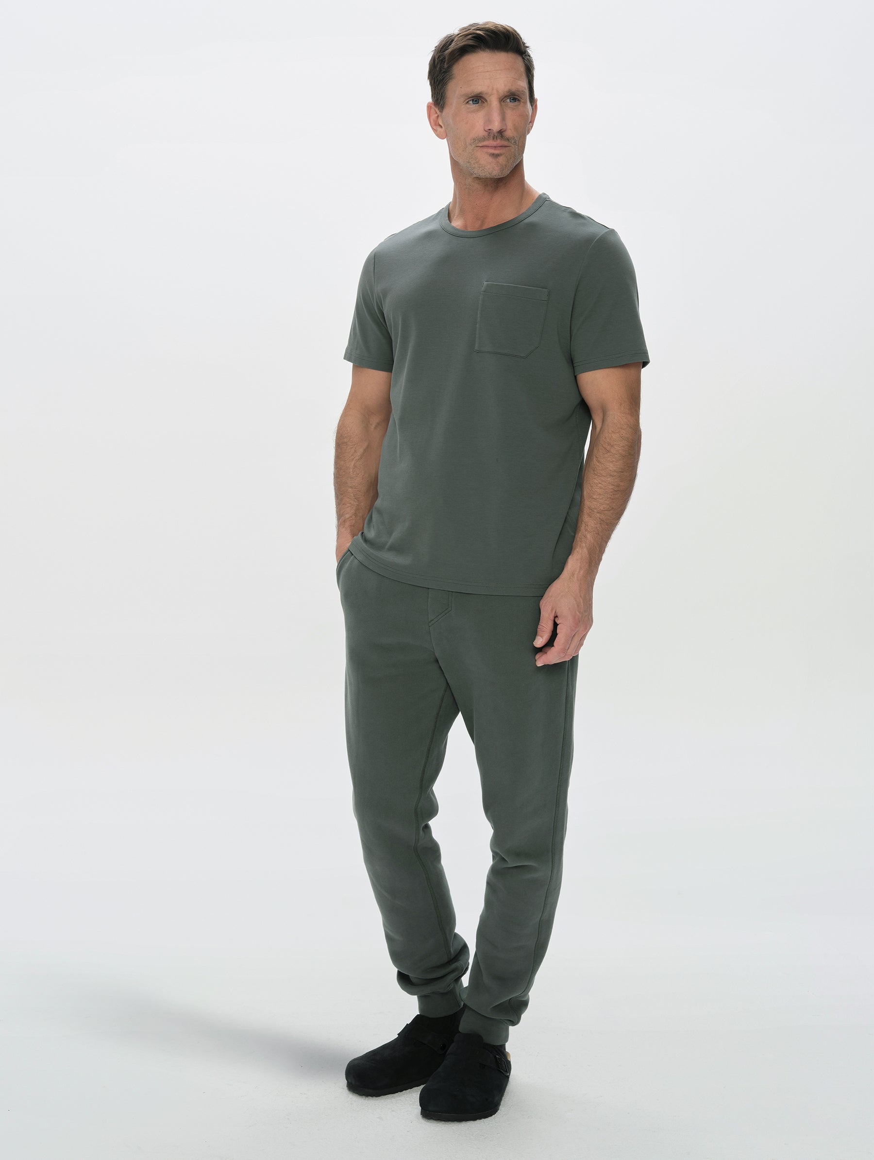 Front, full-body view of man wearing the Rylan Cuffed Sweatpant in Saville Green  from AETHER Apparel.