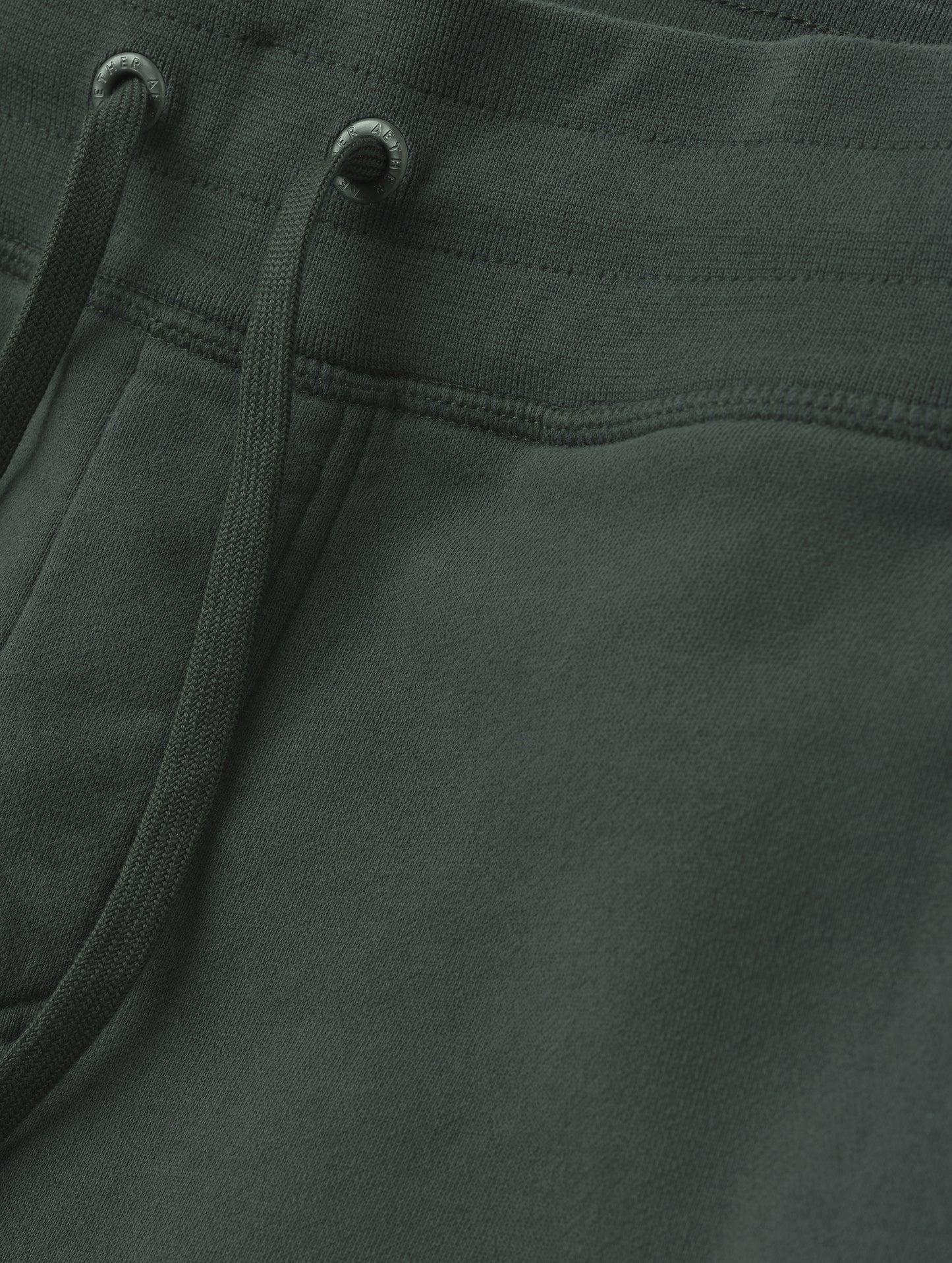 Closeup detailed view of the drawstring closure on the Rylan Cuffed Sweatpant in Saville Green  from AETHER Apparel.