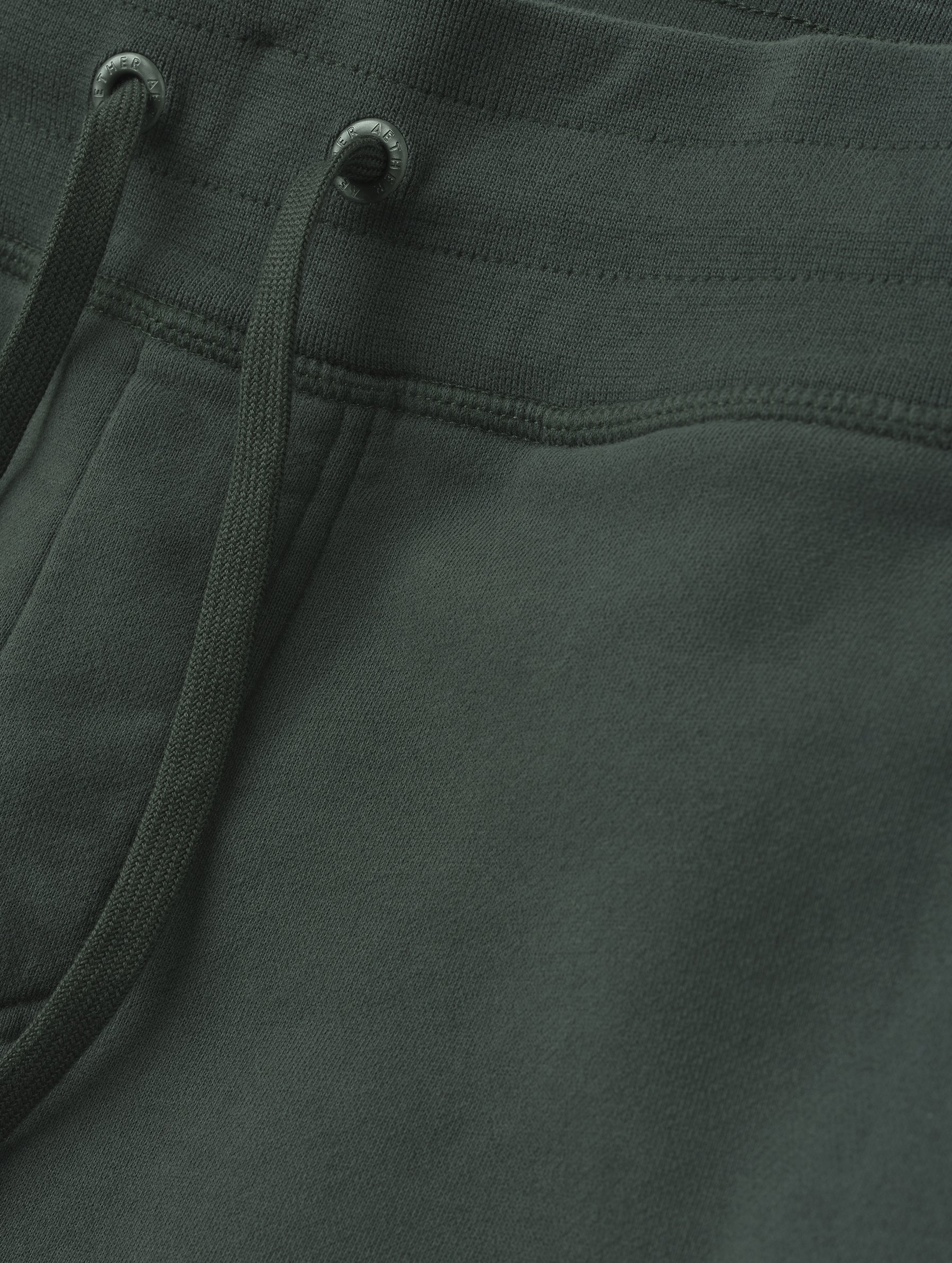 Closeup detailed view of the drawstring closure on the Rylan Cuffed Sweatpant in Saville Green  from AETHER Apparel.