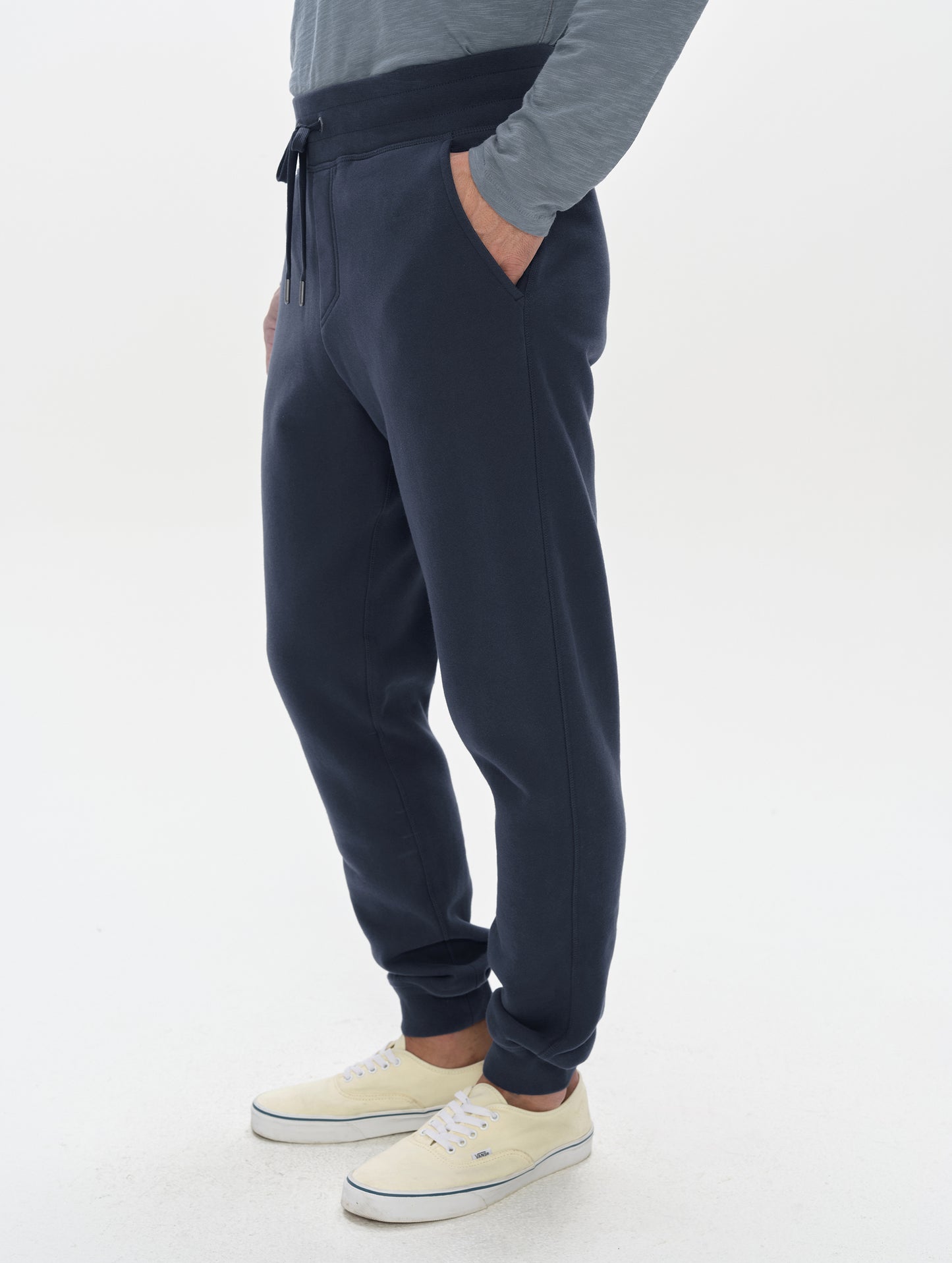 Side profile, lower-body view of man wearing the Rylan Cuffed Sweatpant in Total Eclipse from AETHER Apparel.