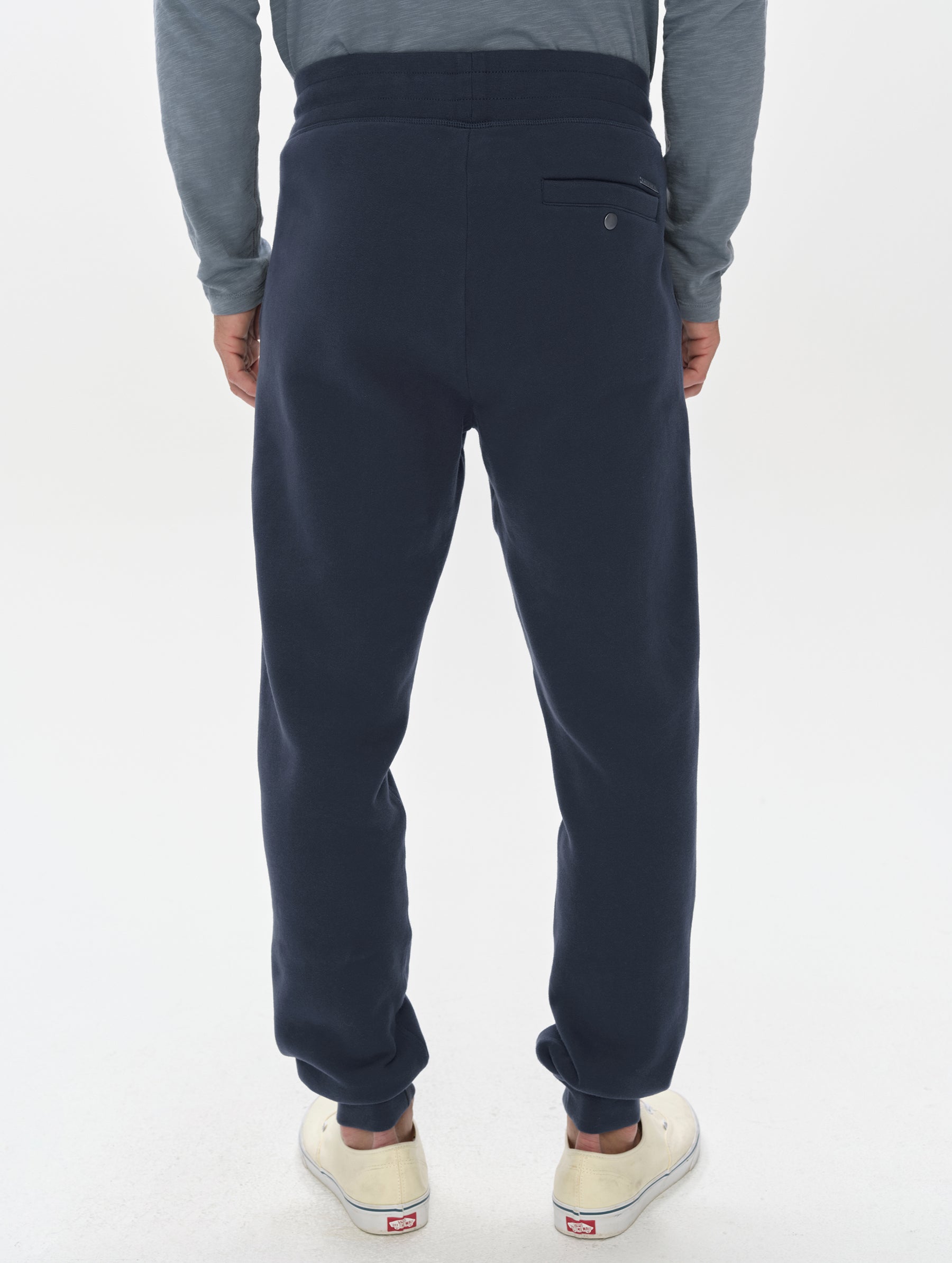 Rear, lower-body view of man wearing the Rylan Cuffed Sweatpant in Total Eclipse from AETHER Apparel.