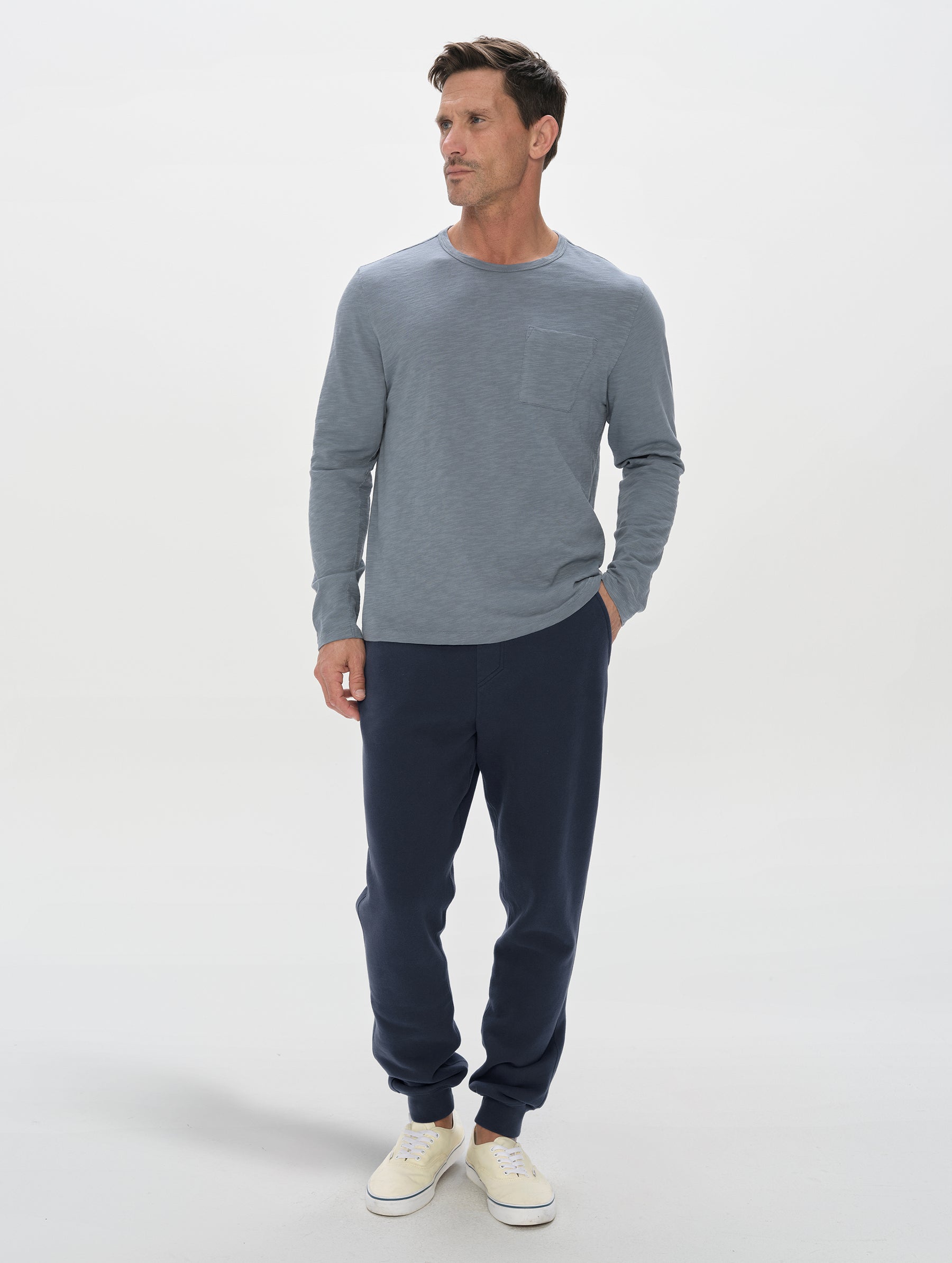 Front, full-body view of man wearing the Rylan Cuffed Sweatpant in Total Eclipse from AETHER Apparel.