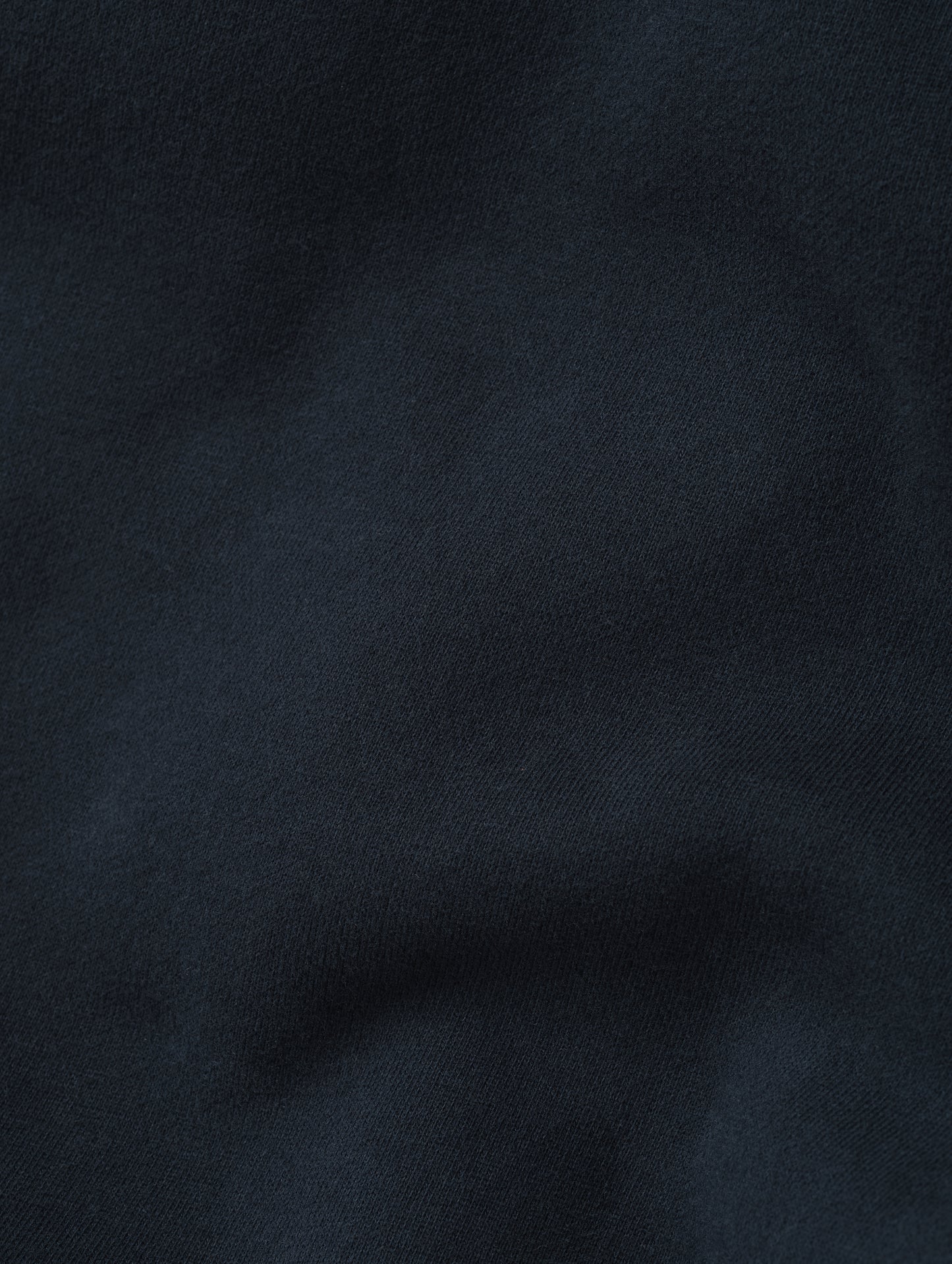 Closeup detailed view of the ultra-soft carbon brushed fleece cotton on the Rylan Sweat Pant in Total Eclipse from AETHER Apparel. 
