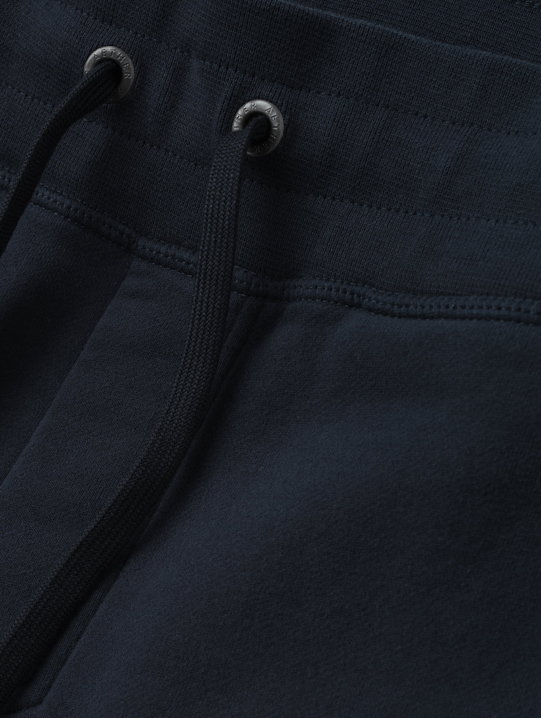 Closeup detailed view of the drawstring closure on the Rylan Cuffed Sweatpant in Total Eclipse from AETHER Apparel.
