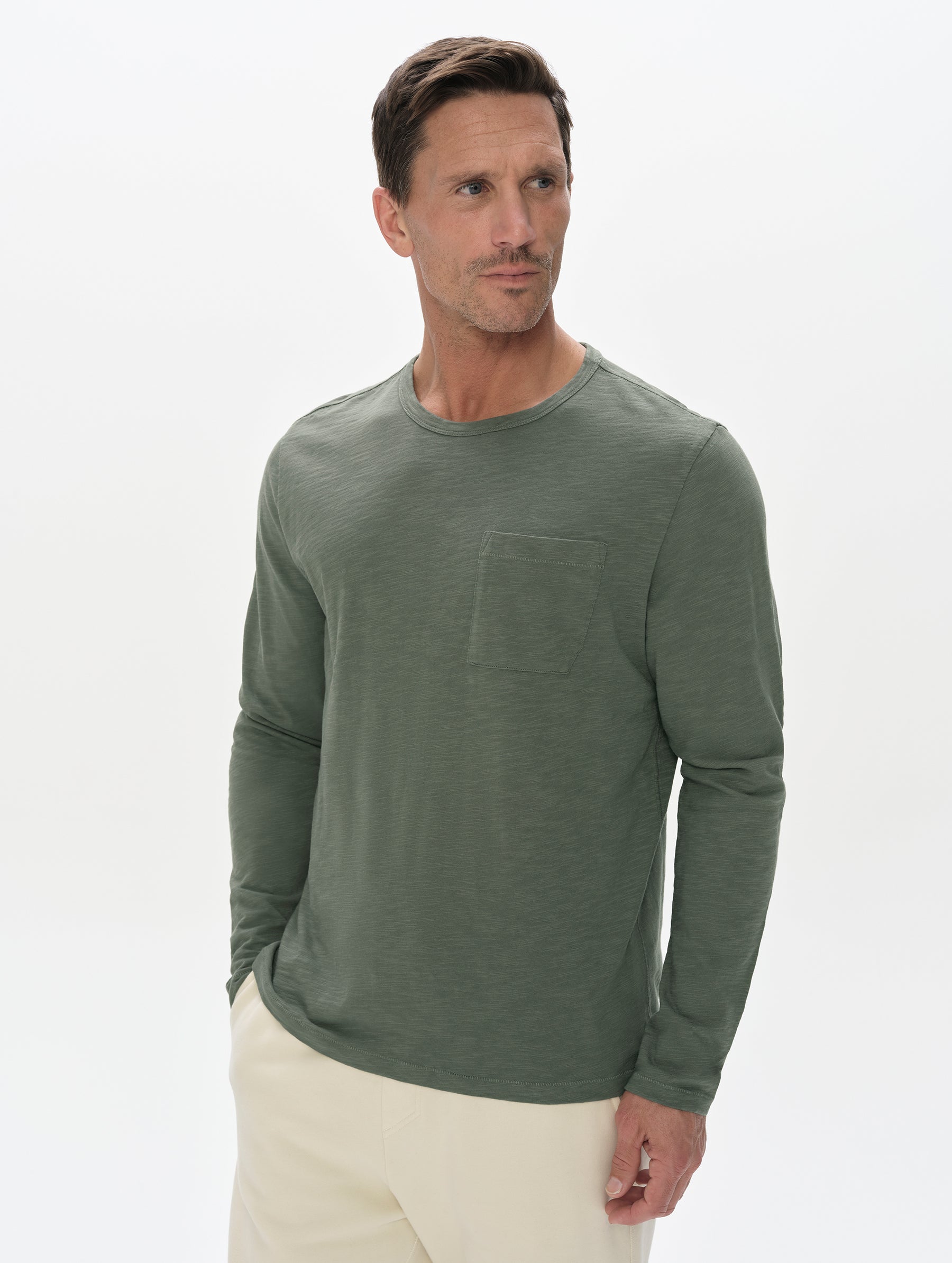 Front, upper-body view of man wearing the Slub Pocket Long-Sleeve Tee 2.0 in Gunmetal from AETHER Apparel.