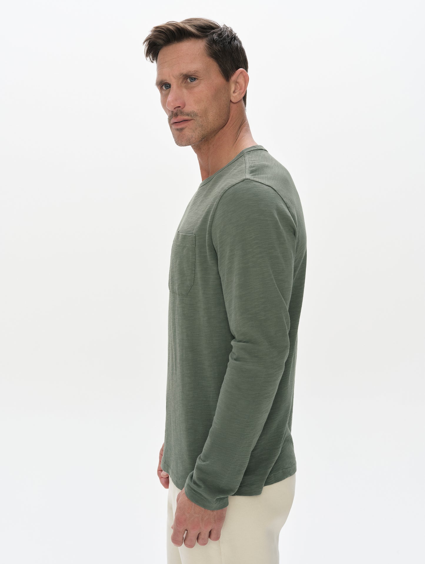 Side profile, upper-body view of man wearing the Slub Pocket Long-Sleeve Tee 2.0 in Gunmetal from AETHER Apparel.
