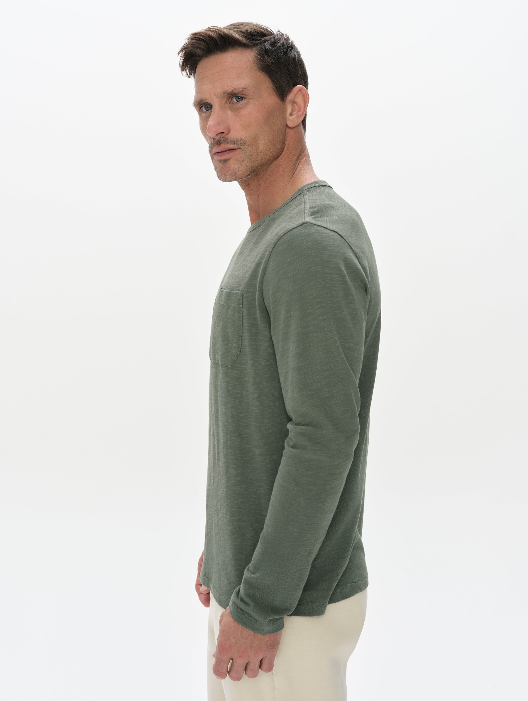 Side profile, upper-body view of man wearing the Slub Pocket Long-Sleeve Tee 2.0 in Gunmetal from AETHER Apparel.