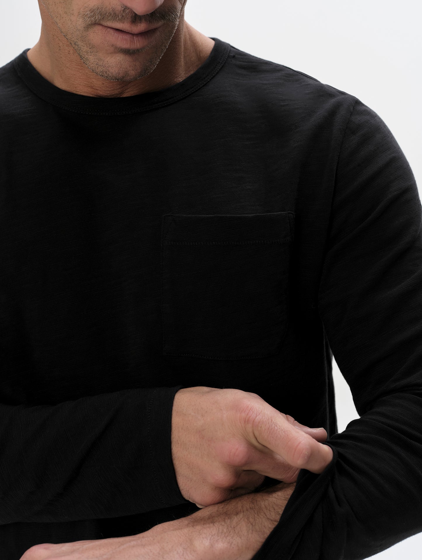 Closeup detailed view of the shoulder and patch pocket on the Slub Pocket Long-Sleeve Tee 2.0 in Onyx Black from AETHER Apparel.