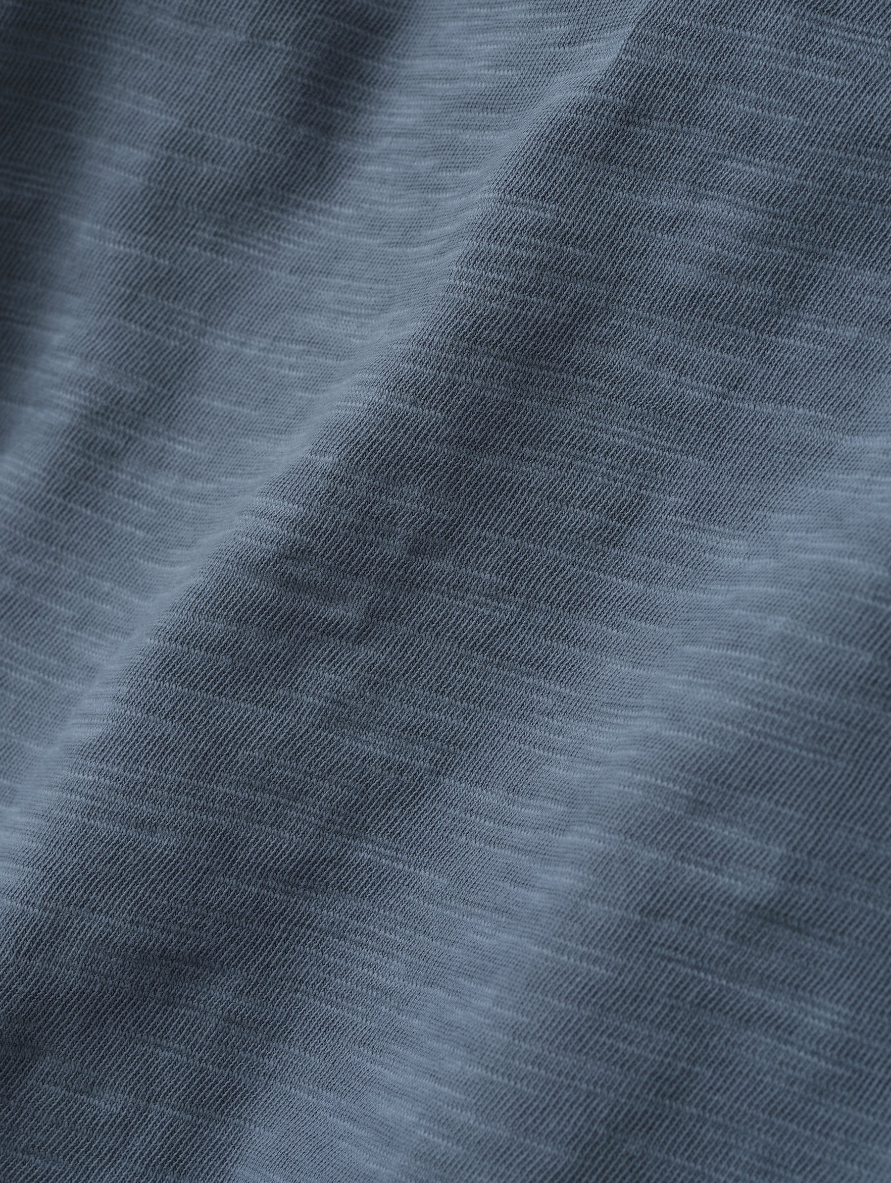 Closeup detailed view of the fabric on the Slub Pocket Long-Sleeve Tee 2.0 in Portal Blue from AETHER Apparel.