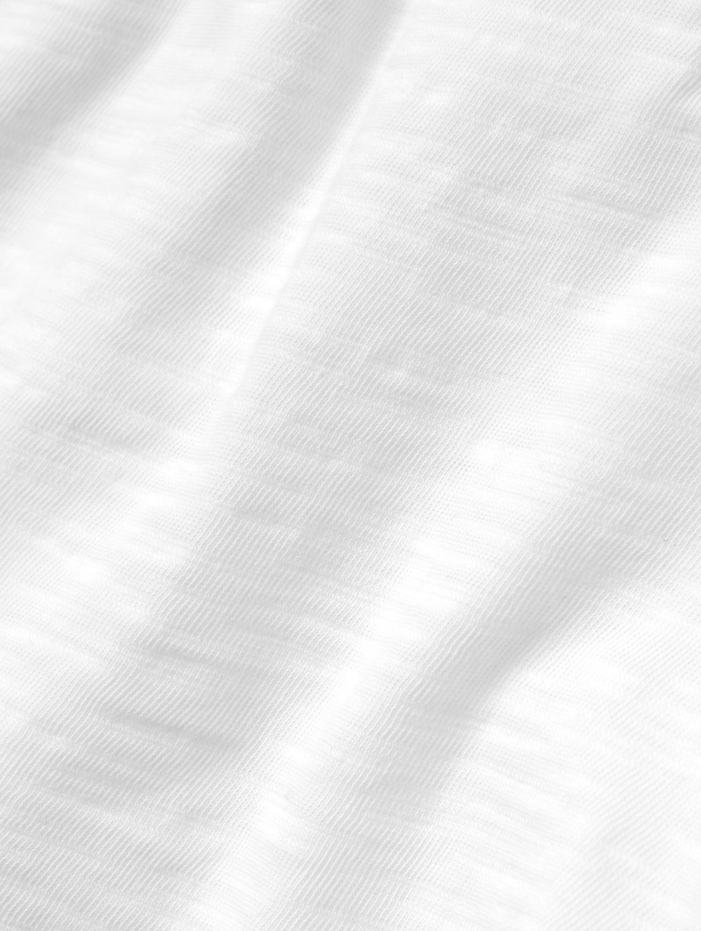 Closeup detailed view of the fabric on the Slub Long-Sleeve Pocket Tee 2.0 in White from AETHER Apparel.