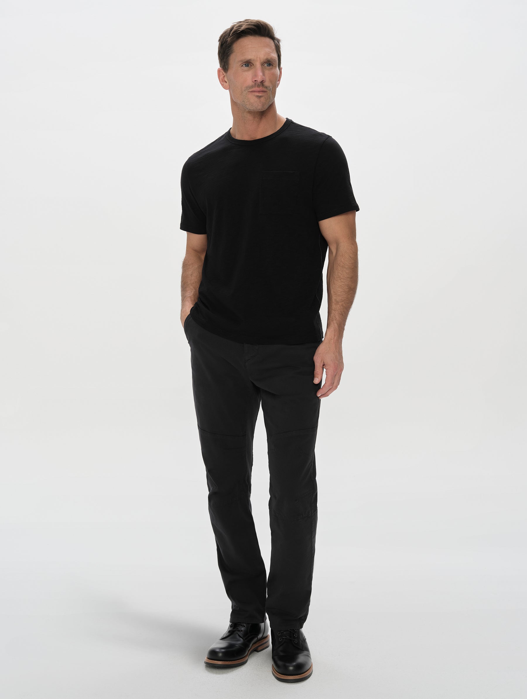 Front, full-body view of man wearing the Slub Pocket Tee 2.0 in Onyx Black from AETHER Apparel.