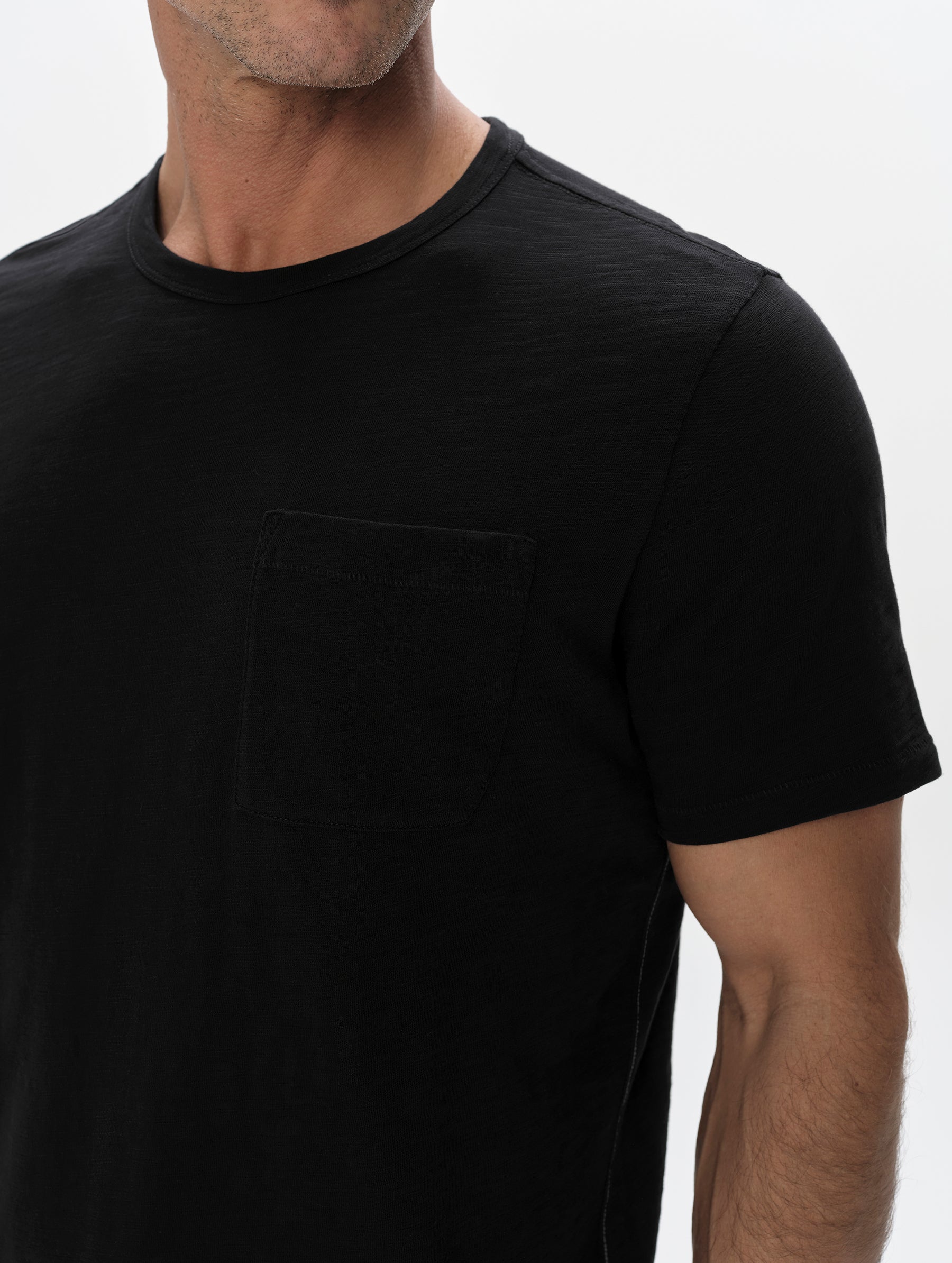 Closeup detailed view of the shoulder and patch pocket on the Slub Pocket Tee 2.0 in Onyx Black from AETHER Apparel.
