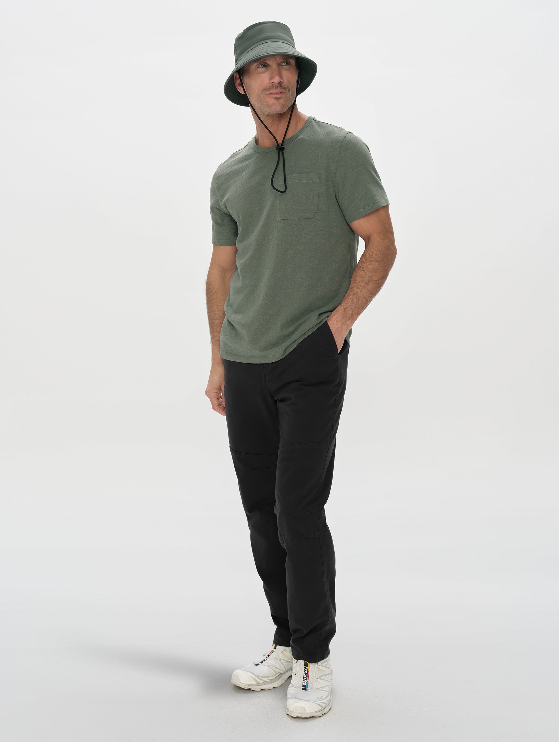 Front, 3/4, full-body view of man wearing the Slub Pocket Tee 2.0 in Gunmetal from AETHER Apparel.