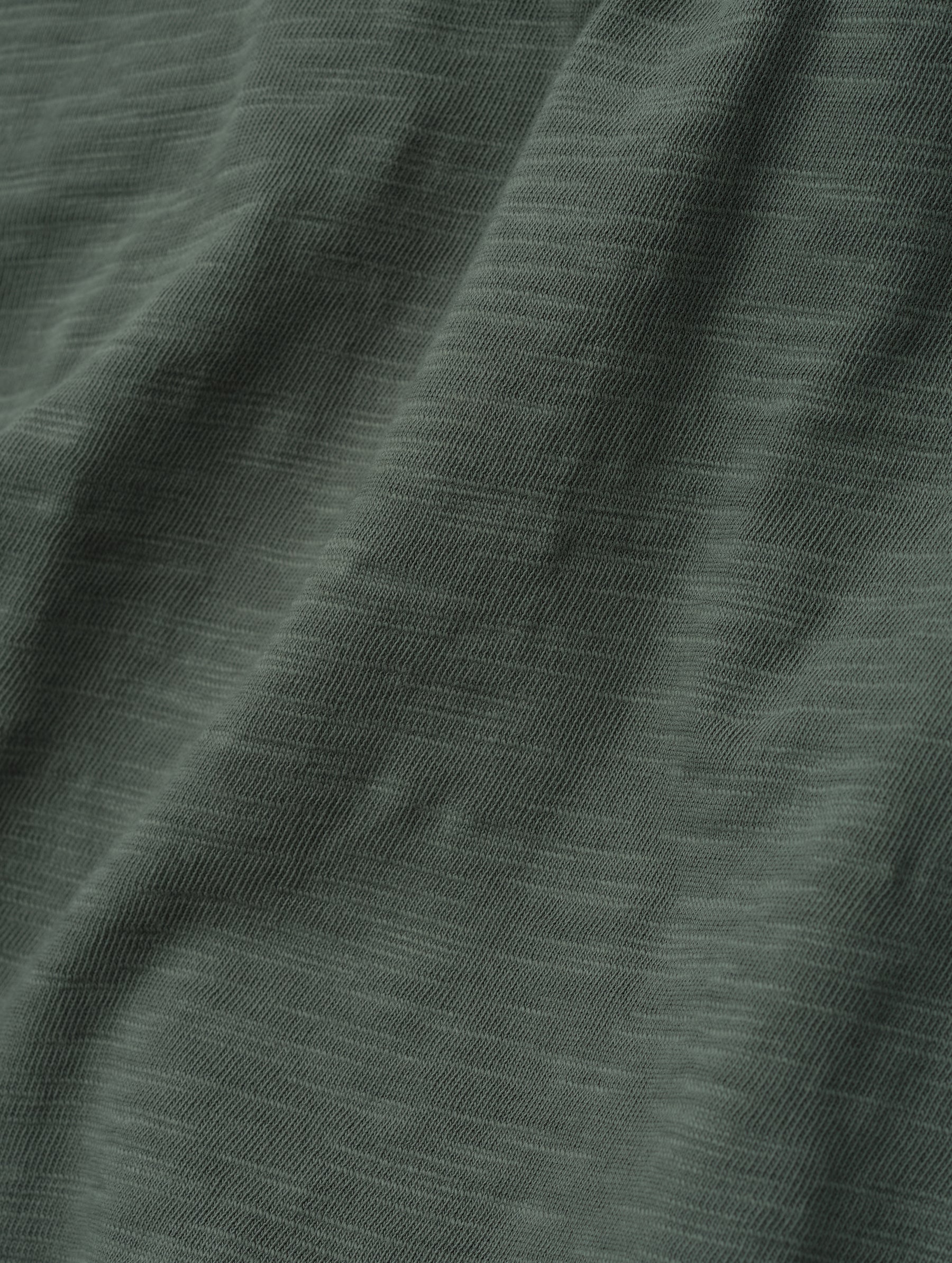 Closeup detailed view of the fabric on the Slub Pocket Tee 2.0 in Gunmetal from AETHER Apparel.