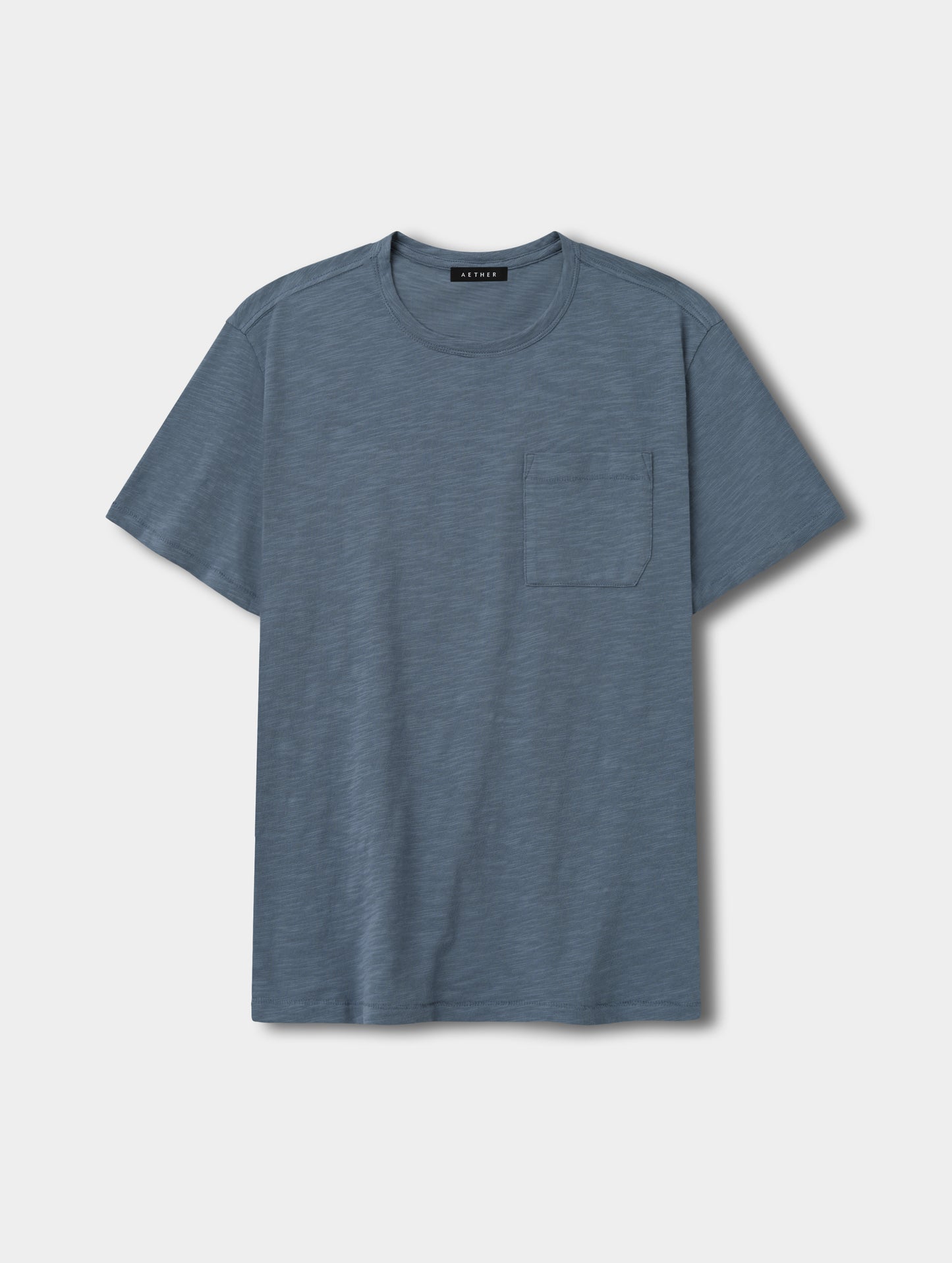 Flat lay view of the Slub Pocket Tee 2.0 in Portal Blue from AETHER Apparel.