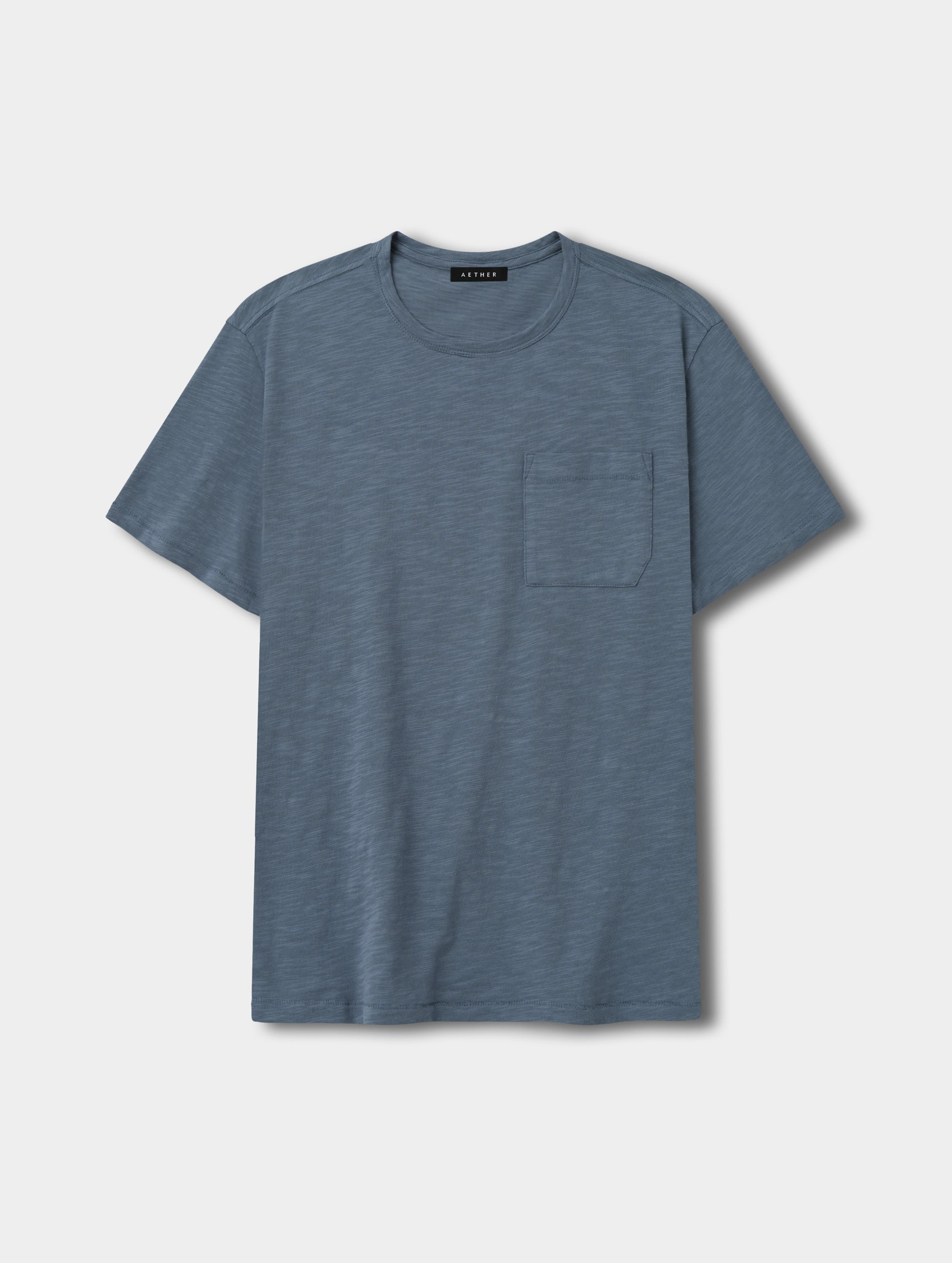 Flat lay view of the Slub Pocket Tee 2.0 in Portal Blue from AETHER Apparel.