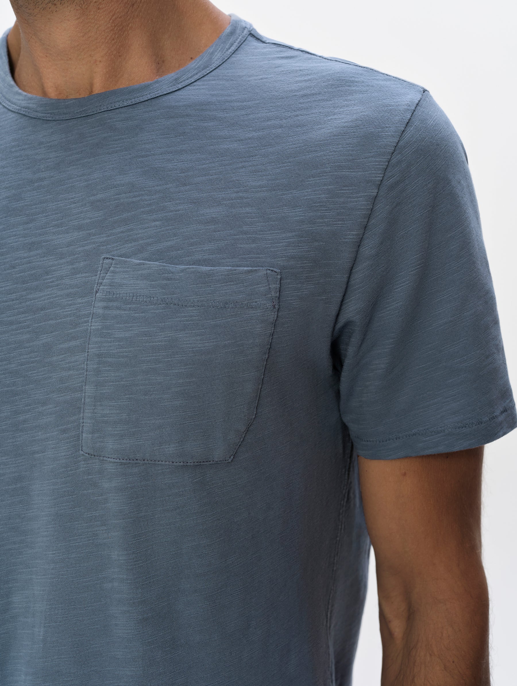 Closeup detailed view of the shoulder and patch pocket on the Slub Pocket Tee 2.0 in Portal Blue from AETHER Apparel.