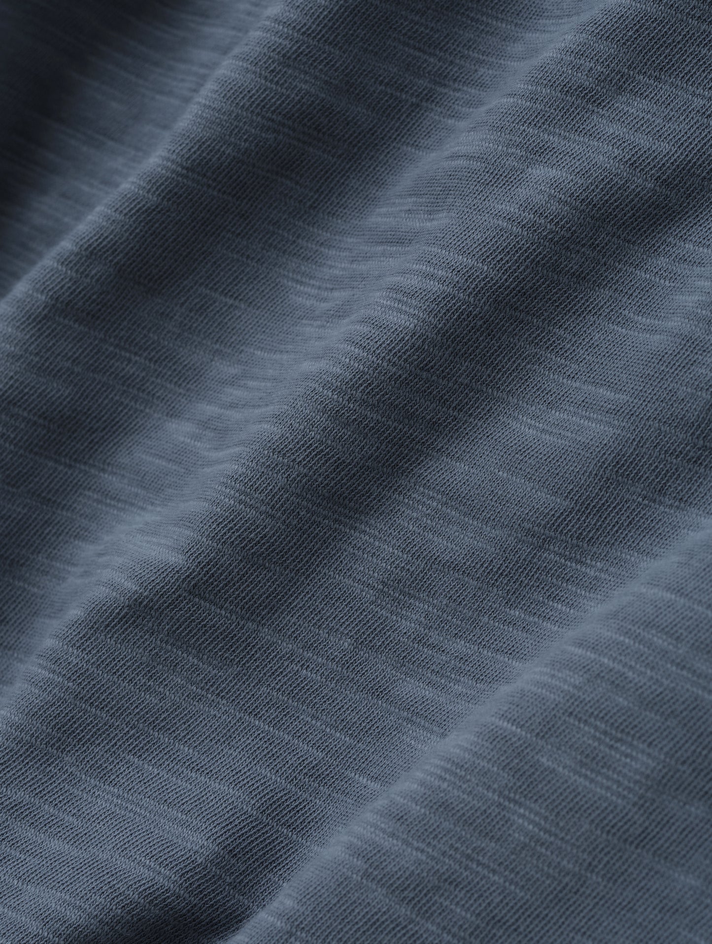 Closeup detailed view of the fabric on the Slub Pocket Tee 2.0 in Portal Blue from AETHER Apparel.