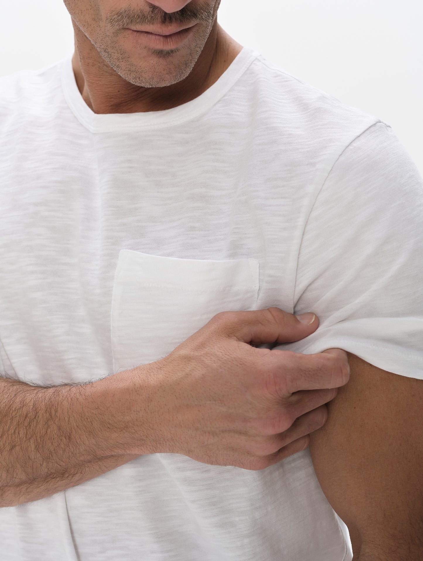 Closeup detailed view of the chest pocket and shoulder on the Slub Pocket Tee 2.0 in White from AETHER Apparel.