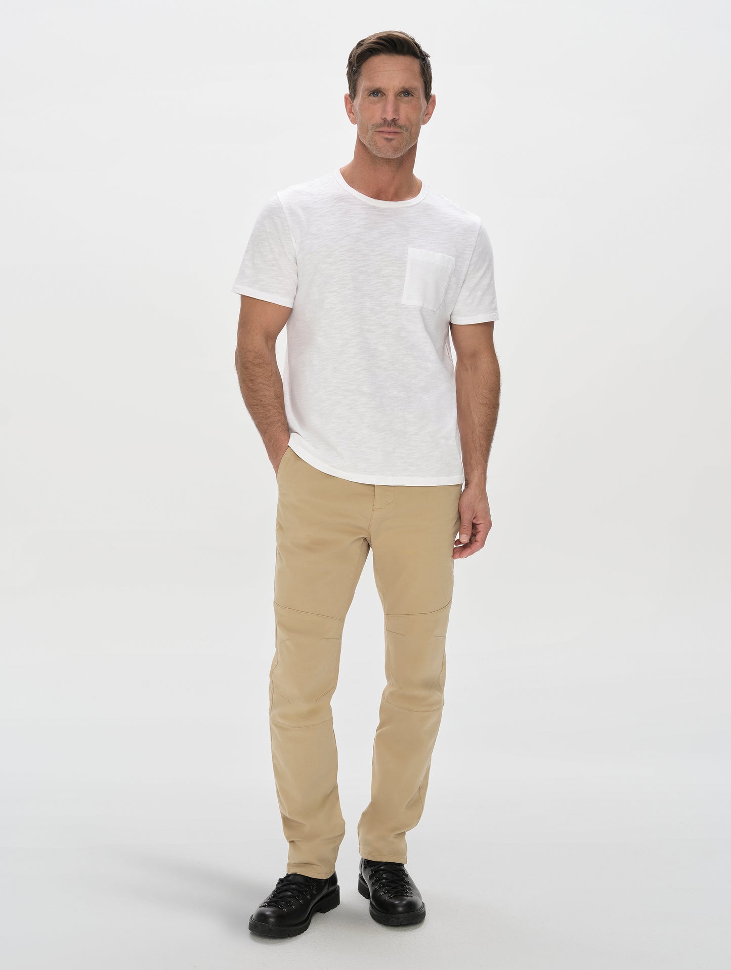 Front, full-body view of man wearing Slub Pocket Tee 2.0 in White from AETHER Apparel.