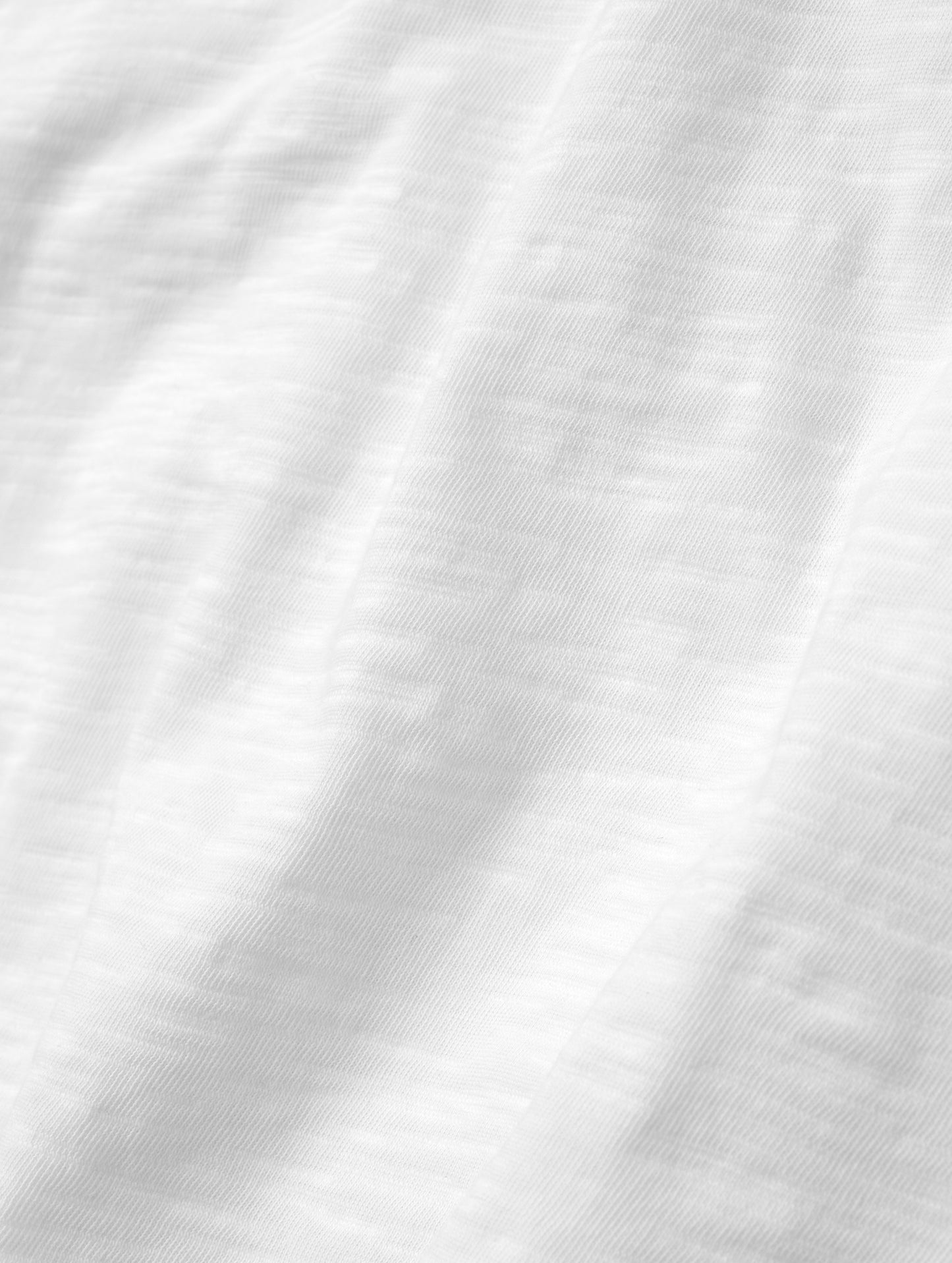 Closeup detailed view of the fabric on the Slub Pocket Tee 2.0 in White from AETHER Apparel.