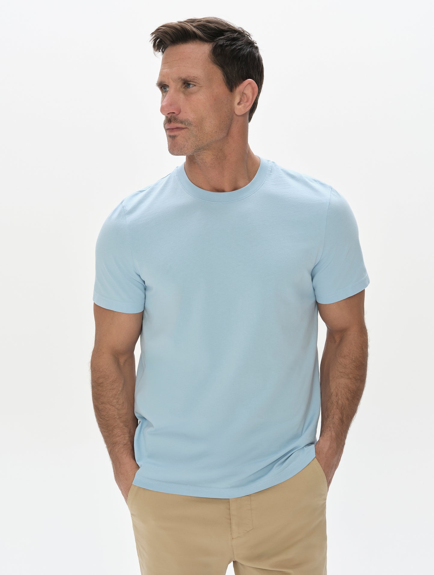 Front, upper-body view of man wearing the Standard Tee in Cloud Blue from AETHER Apparel.