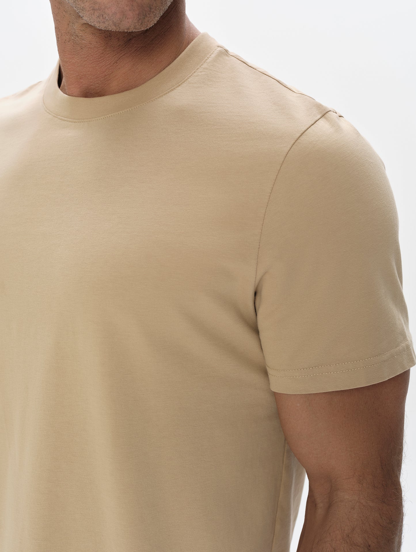 Closeup detailed view of the shoulder on the Standard Tee in Desert Tan from AETHER Apparel.