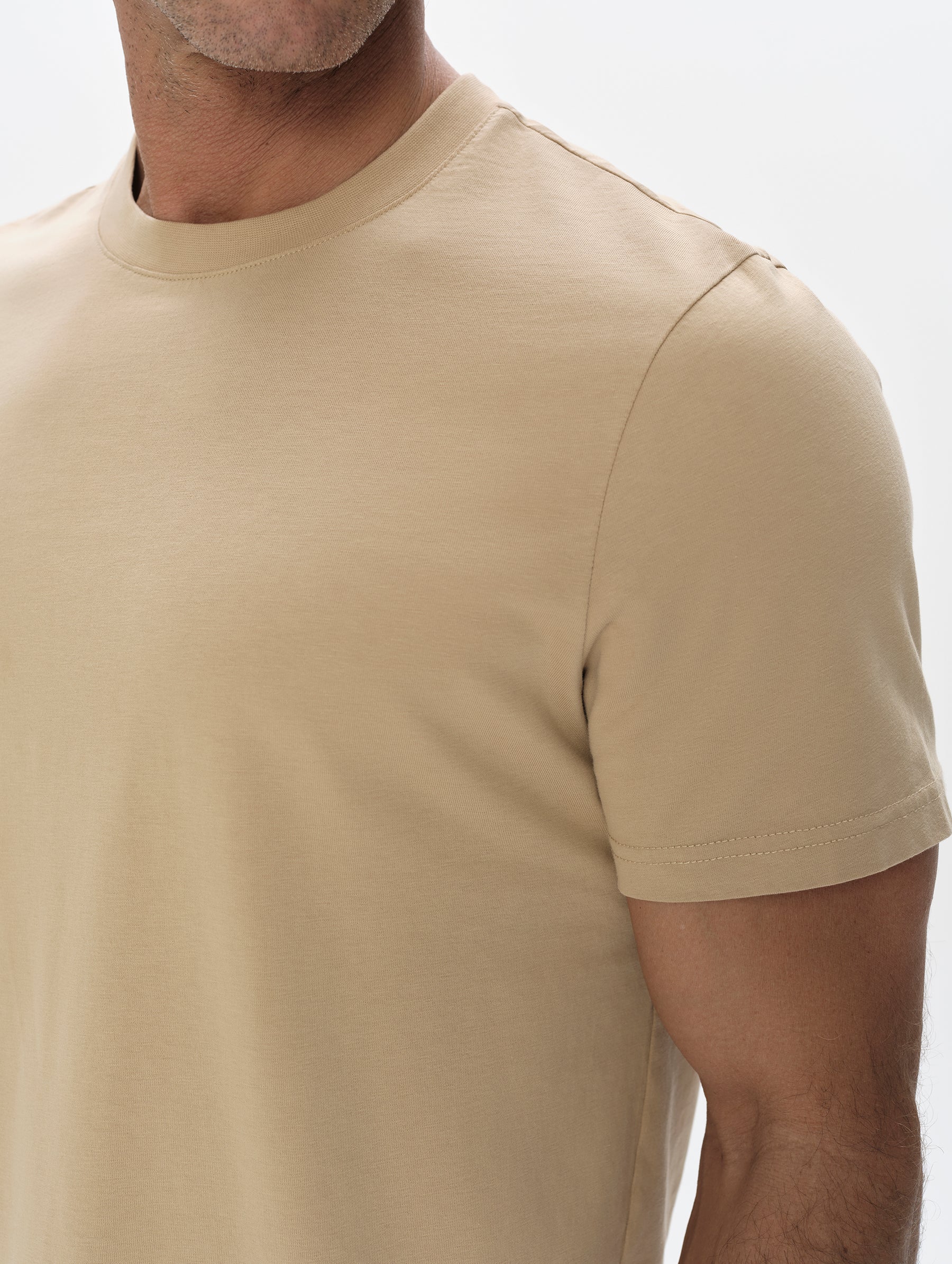 Closeup detailed view of the shoulder on the Standard Tee in Desert Tan from AETHER Apparel.