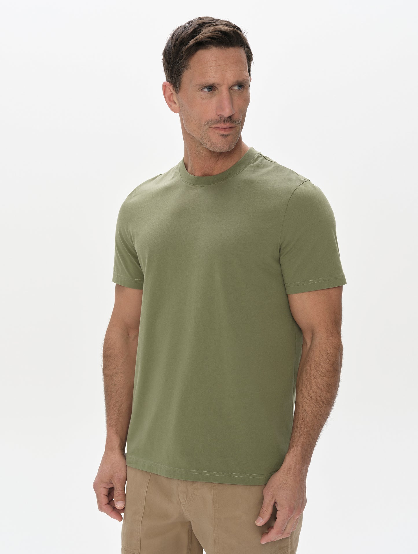 Front, upper-body view of man wearing the Standard Tee in Fern Green from AETHER Apparel.
