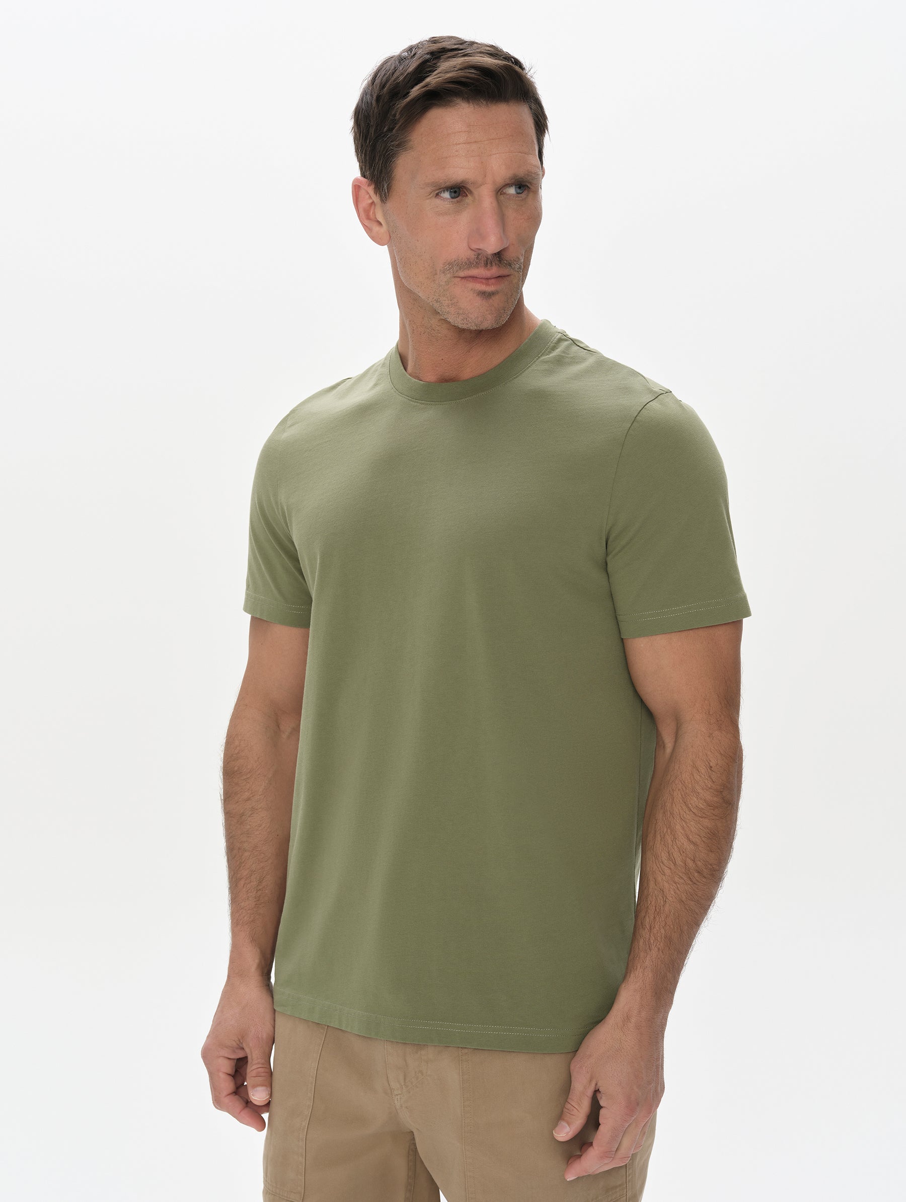 Front, upper-body view of man wearing the Standard Tee in Fern Green from AETHER Apparel.