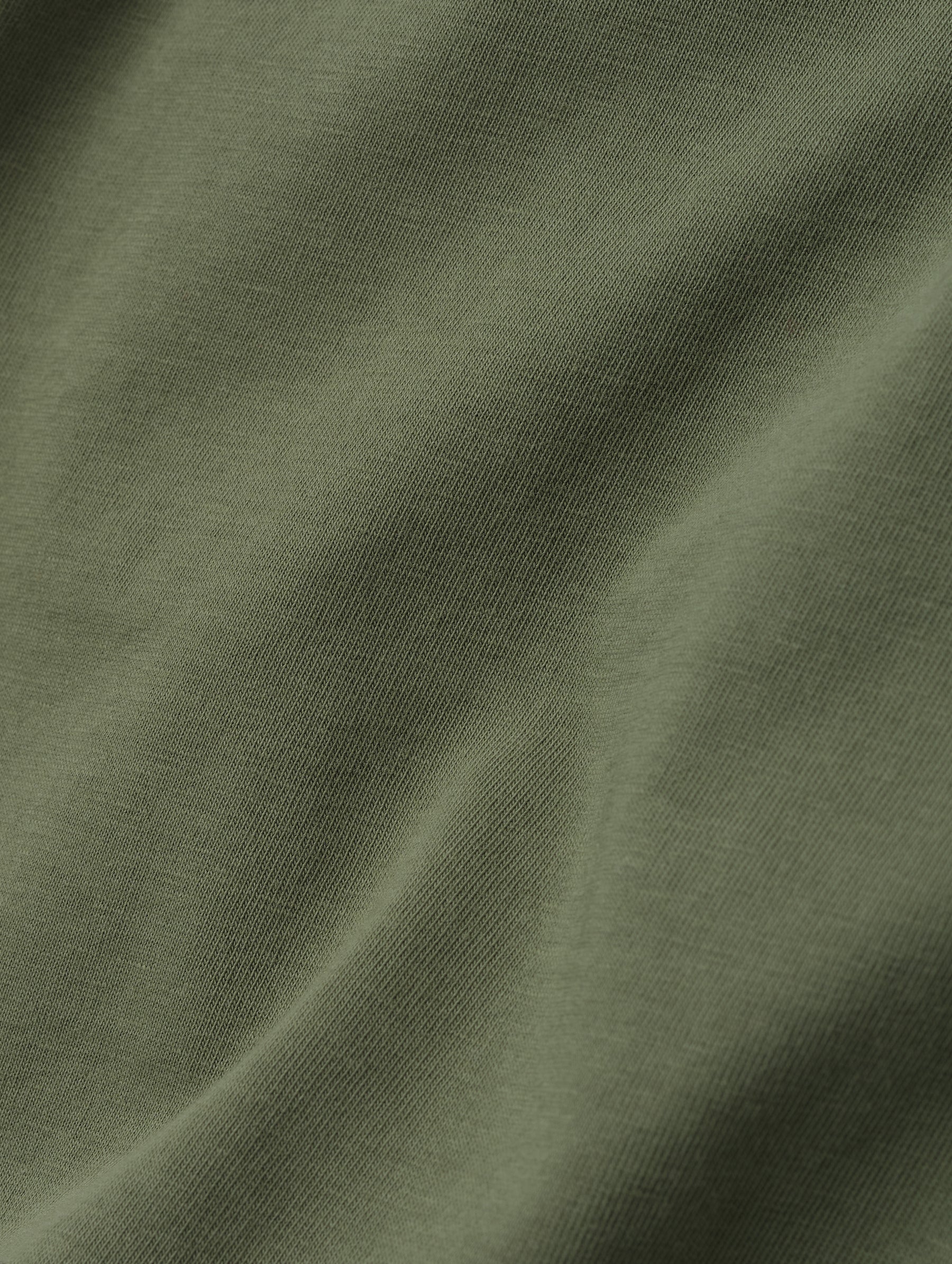 Closeup detailed view of the fabric on the Standard Tee in Fern Green from AETHER Apparel.