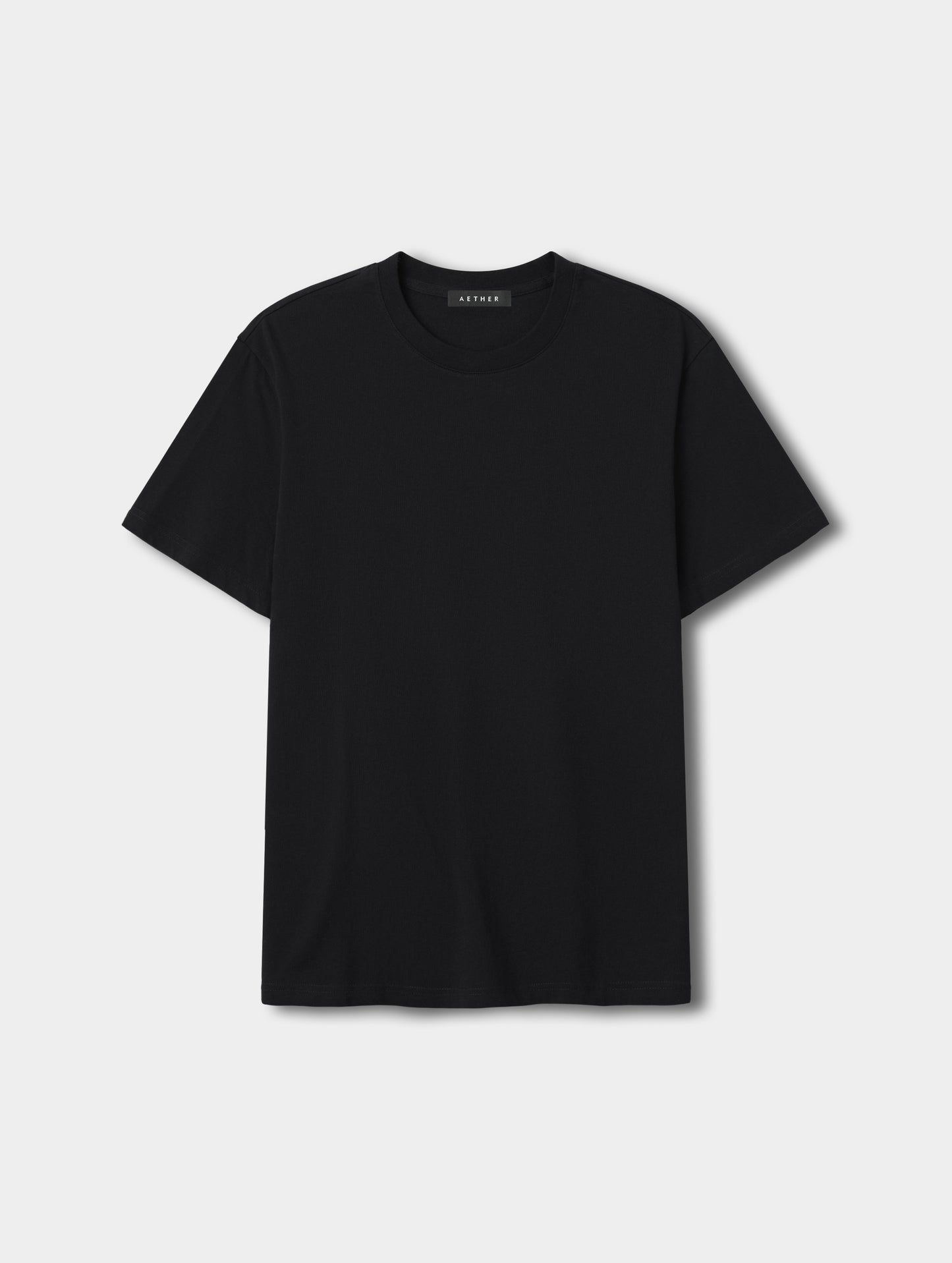 Flat lay view of the Standard Tee in Onyx Black from AETHER Apparel.