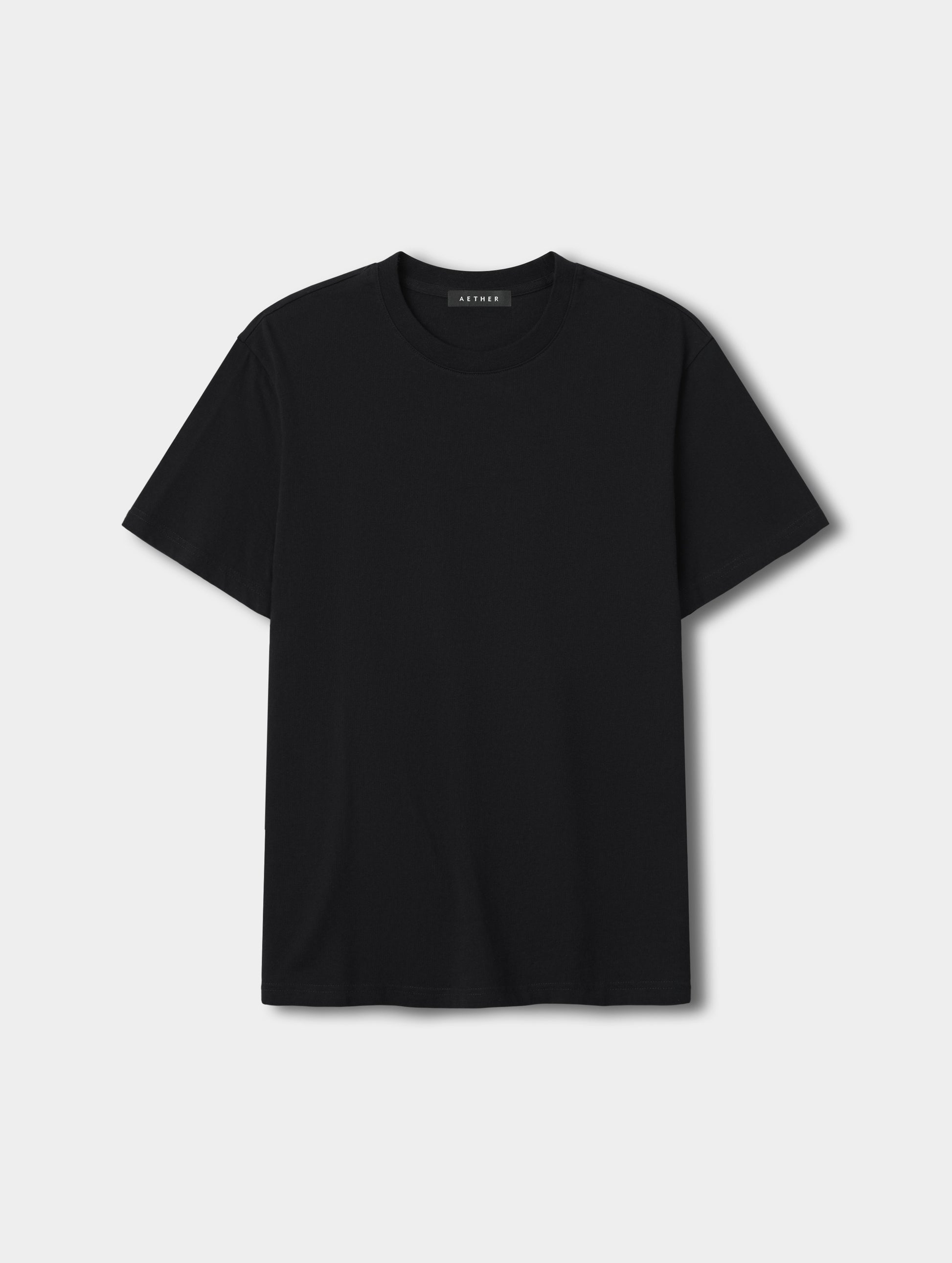 Flat lay view of the Standard Tee in Onyx Black from AETHER Apparel.