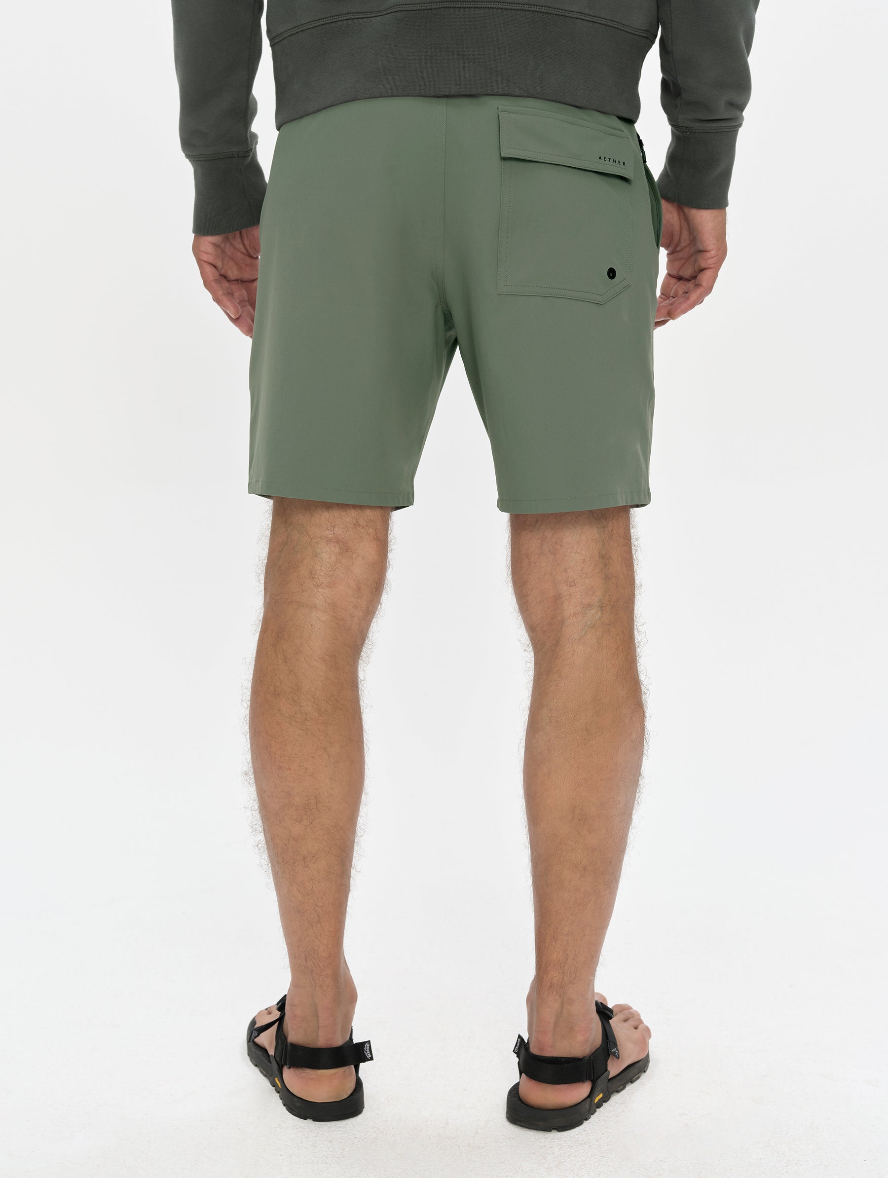 Rear, lower-body view of man wearing the Velo Short in Gunmetal from AETHER Apparel.