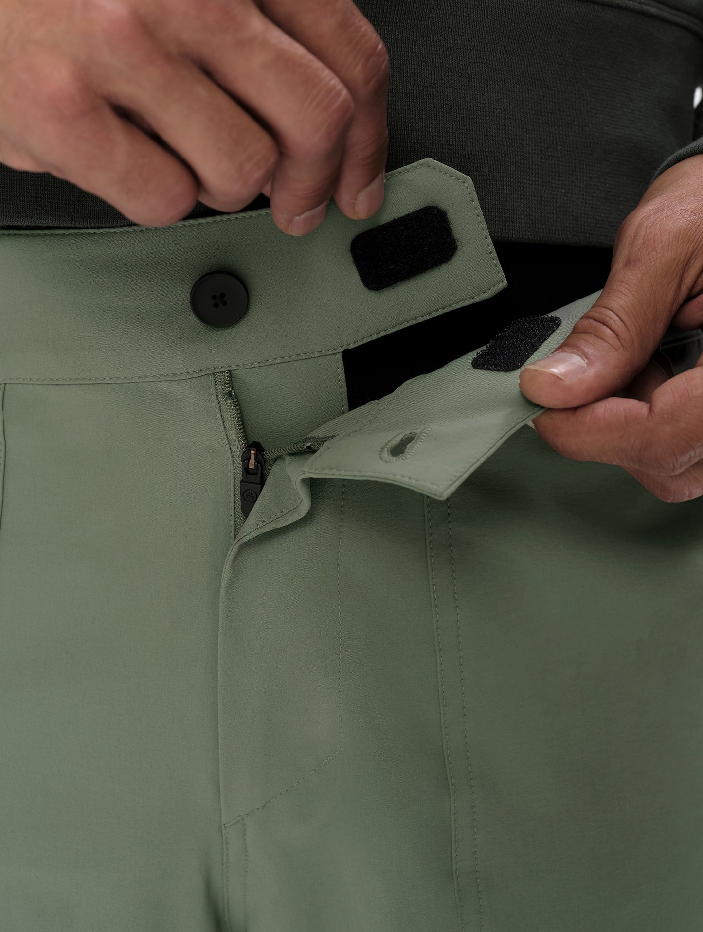 Closeup detailed view of the Velcro and button-secured waistband closure on the Velo Short in Gunmetal from AETHER Apparel.