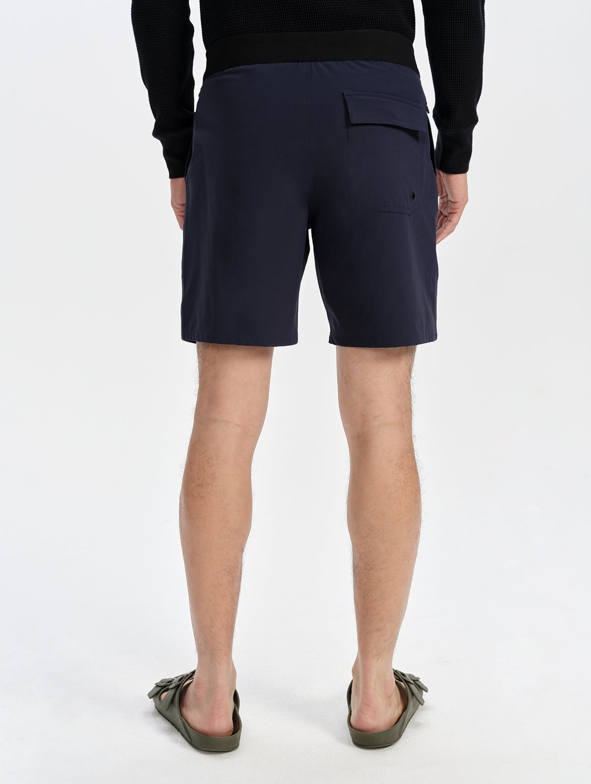 Lower-body back view of the Velo Short in Total Eclipse, showing the elastic back waistband and flap back pocket.